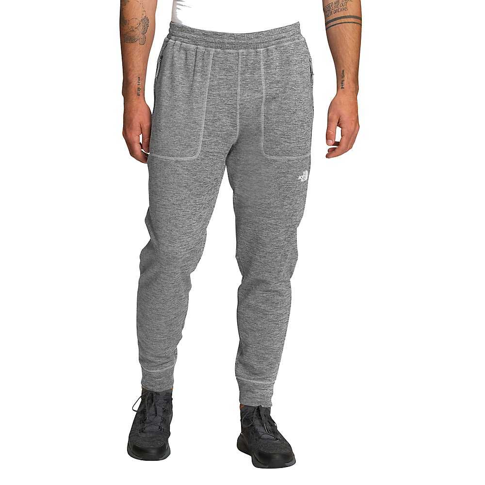 A person is shown from the waist down, facing forward against a white background, wearing The North Face Mens Canyonlands Jogger in gray with black sneakers.