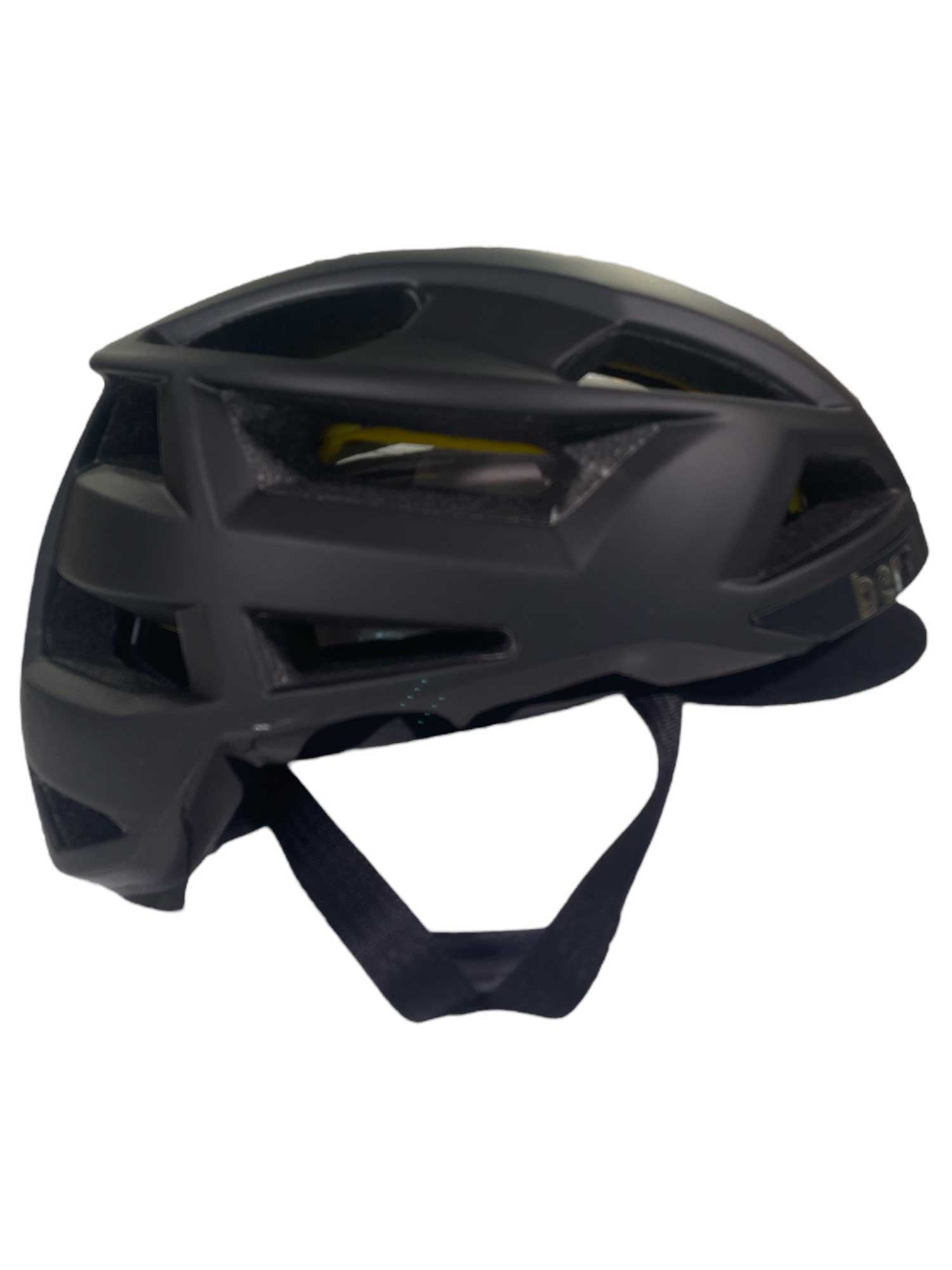 The Bern FL-1 Pave MIPS Helmet - Bike is a black, lightweight helmet with multiple ventilation slots, a front visor, and an adjustable chin strap. Shown from the side against a white background.