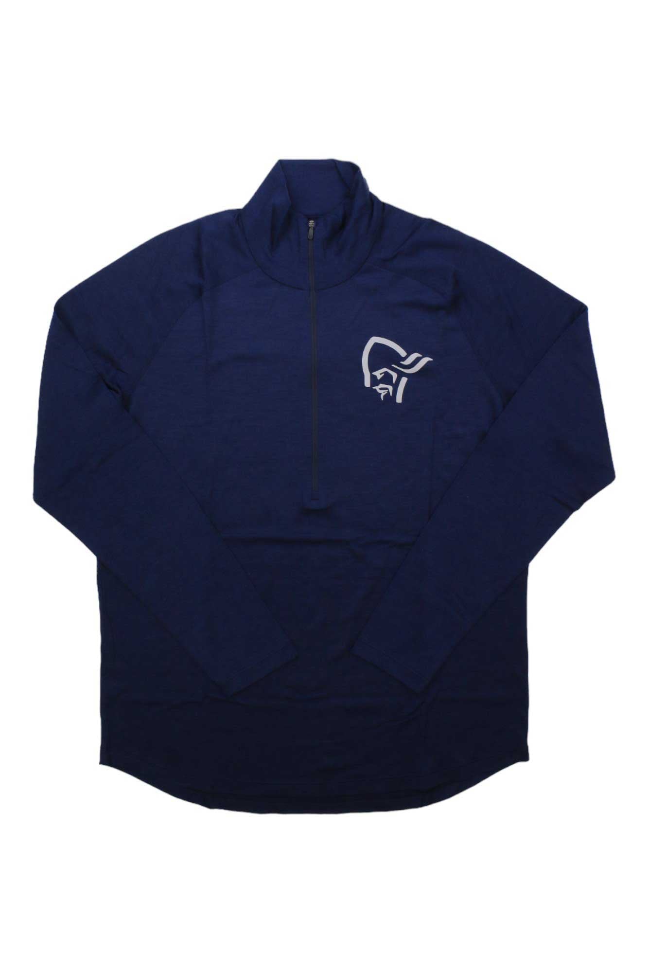 The Norrona Mens Pureull Zip Neck Top is a navy blue, long-sleeve pullover for men featuring a white stylized pirate logo on the left chest. This moisture-wicking top is shown laid flat on a white background.