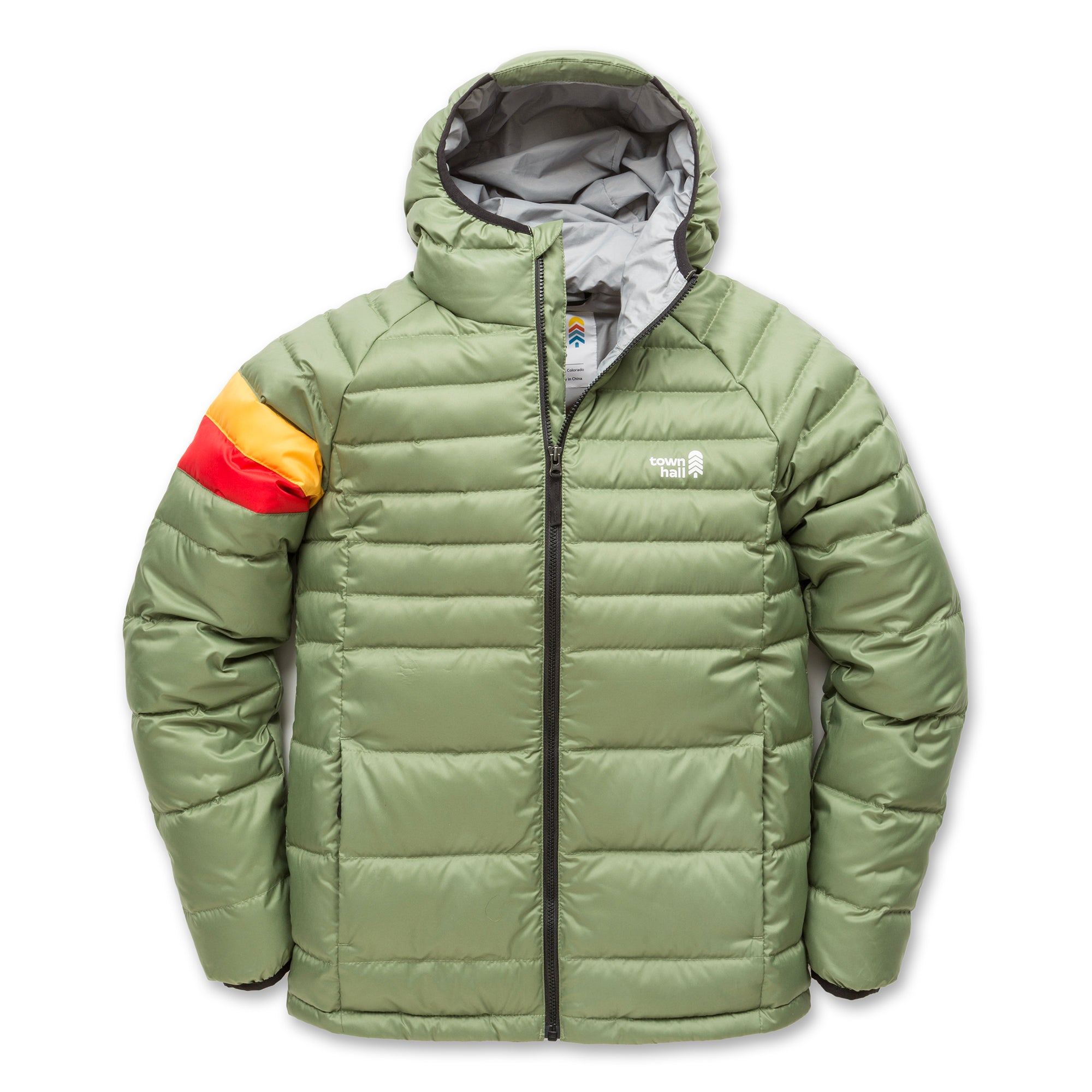 The Down Town Kids Puffy is a green puffer jacket with a hood, front zipper, and two side pockets. It has recycled down insulation, orange, red, and yellow sleeve stripes, plus a small white logo on the left chest.