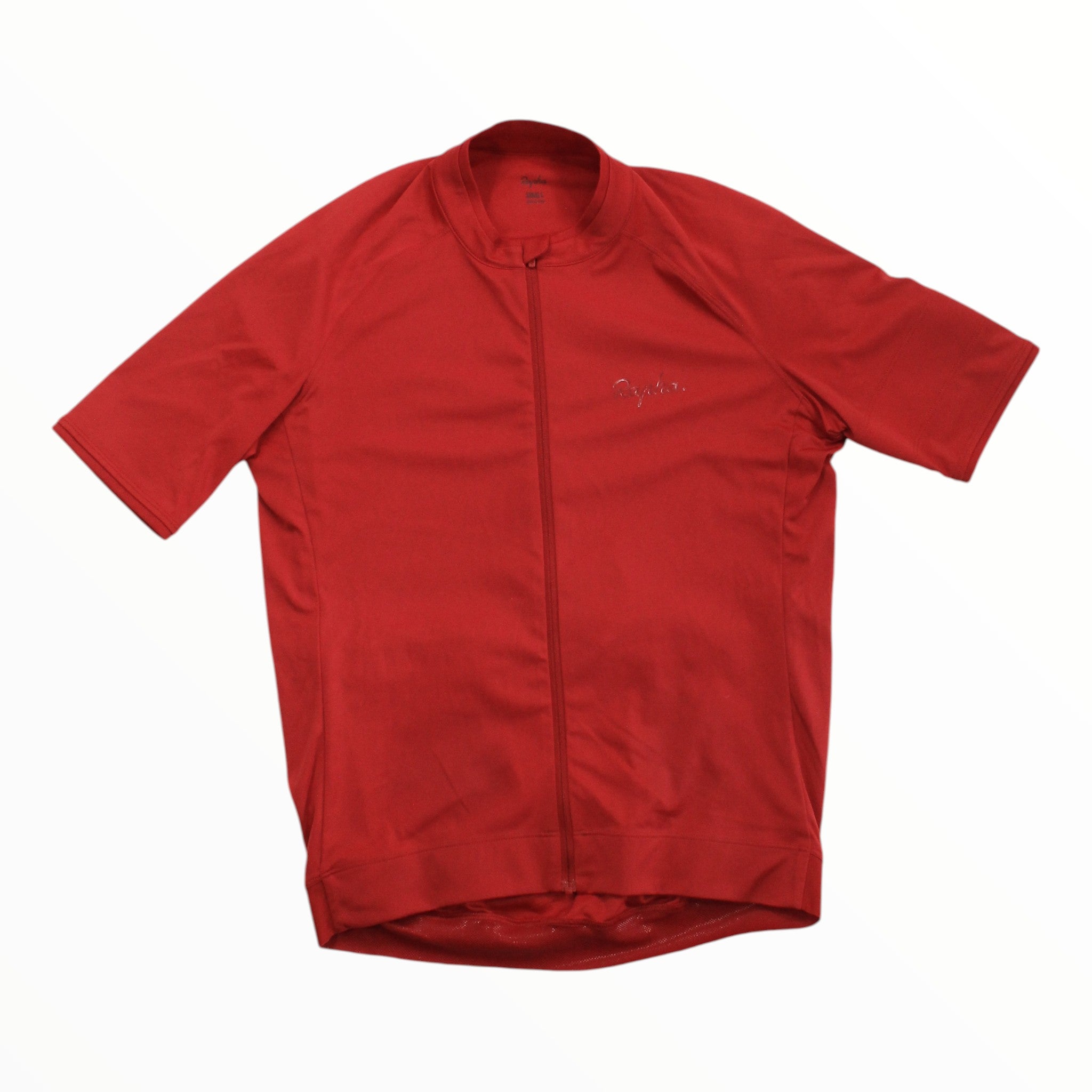 A Rapha Mens Core Jersey in red, featuring short sleeves, a full-length front zipper, and a subtle Rapha logo on the left chest, is laid flat on a white background—showcasing high-performance and comfortable cycling apparel by Rapha.