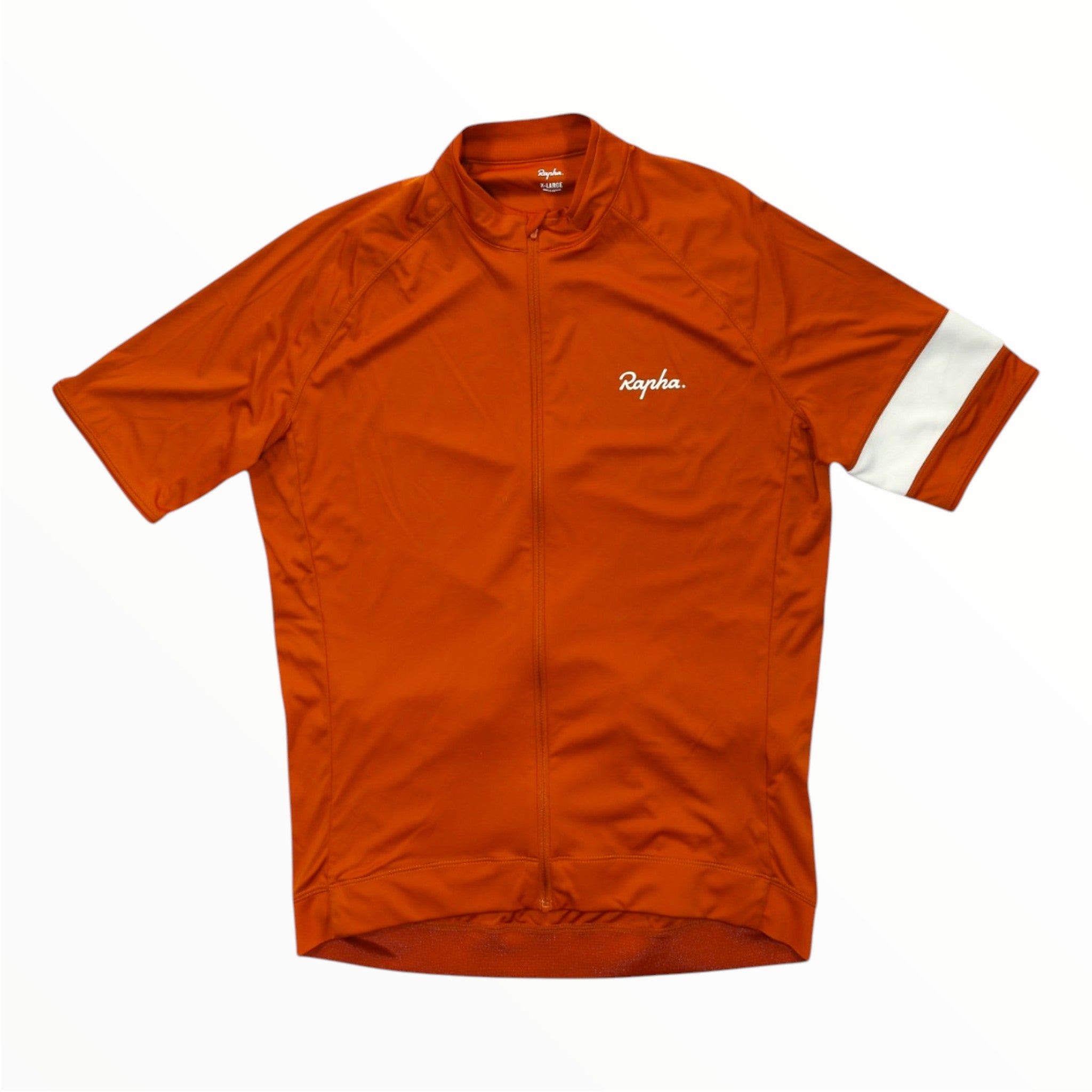 The Rapha Mens Core Jersey is a vibrant orange, short-sleeve cycling jersey featuring a full-length front zipper, the iconic white Rapha logo on the chest, and a distinctive single white band on the left sleeve. Displayed against a plain white background, this standout piece of men’s cycling apparel from Rapha is front and center.