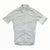 The Rapha Mens Core Jersey by Rapha is a light gray, short-sleeve cycling jersey featuring a full-length front zipper, a subtle chest logo, and a small white accent on the left sleeve. Laid flat on a white background, this premium men’s cycling apparel is an excellent choice for discerning riders.