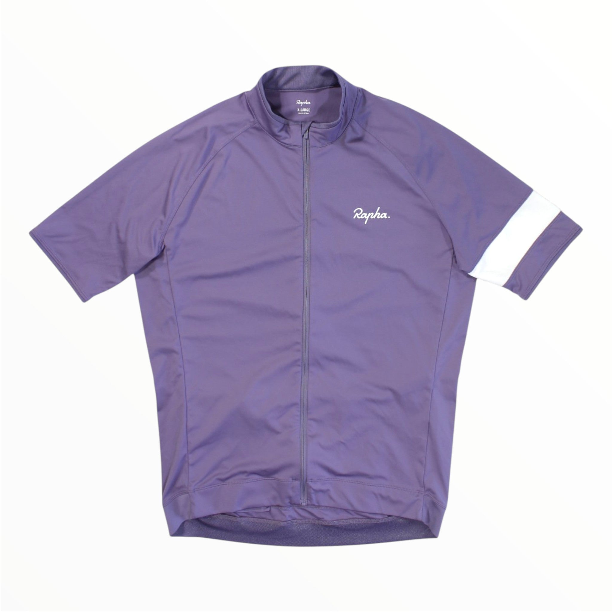 The Rapha Mens Core Jersey is a purple short-sleeve cycling jersey featuring a front zipper, a small white Rapha logo on the left chest, and a distinctive white stripe on the left sleeve. Displayed on a white background, this essential piece of men’s cycling apparel combines style and performance from the renowned brand Rapha.