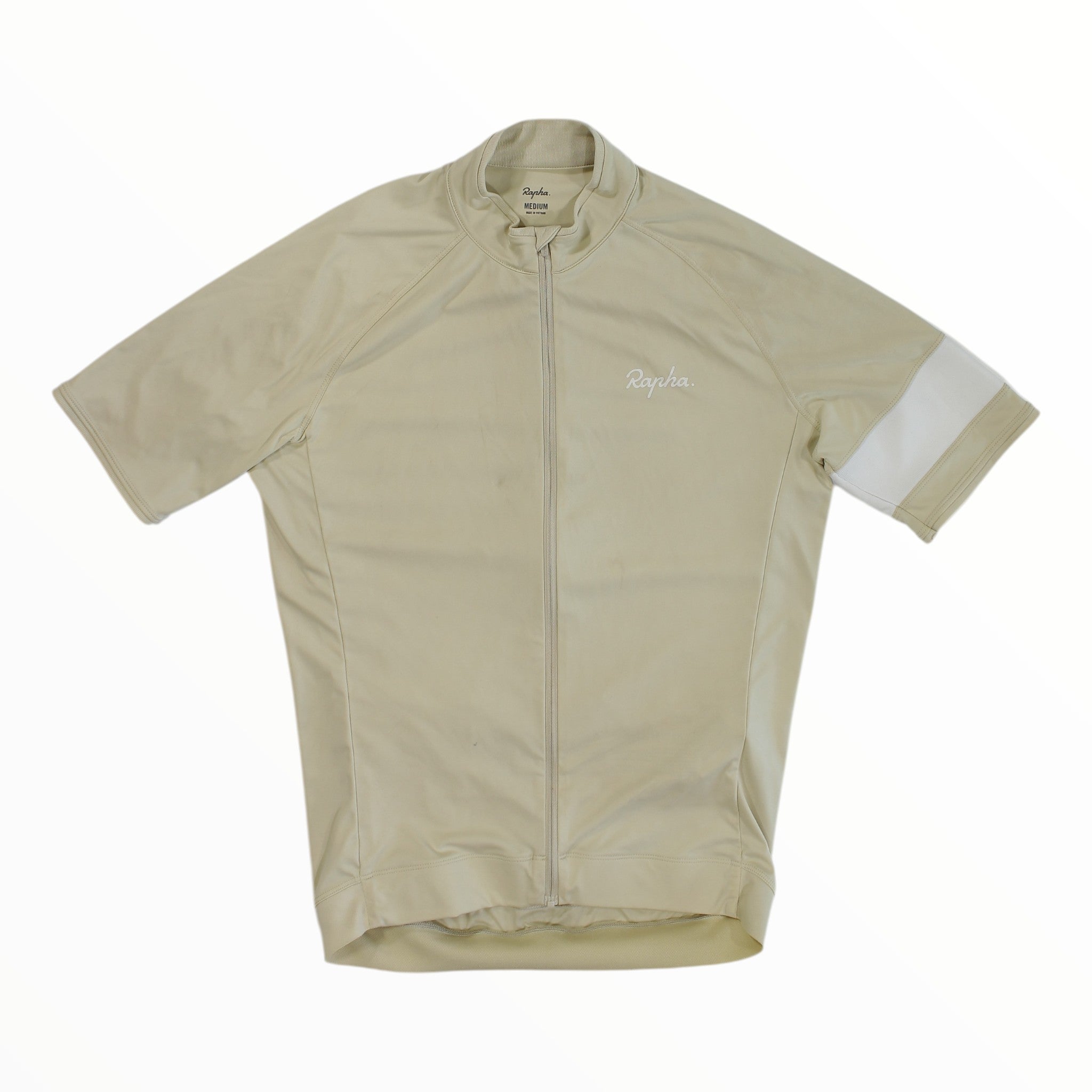 The Rapha Mens Core Jersey by Rapha is a beige, short-sleeve cycling jersey featuring a front zipper and a distinctive white stripe on the left sleeve, shown laid flat against a white background—making it a standout in men’s cycling apparel.