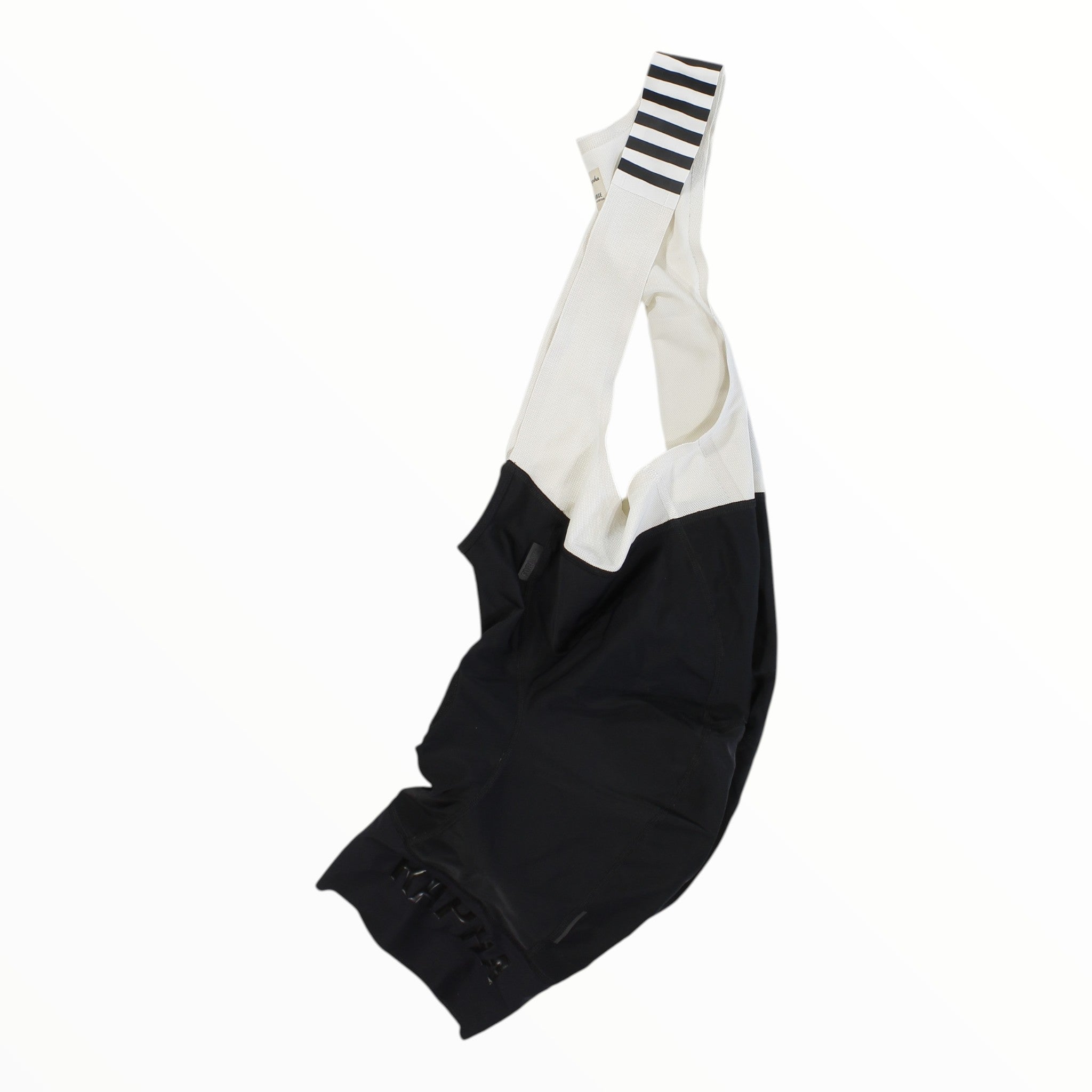 Rapha Pro Team bib shorts with white upper and black lower panels, striped cuffs, RAPHA print