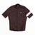 A maroon Rapha Mens Core Jersey featuring short sleeves, a full-length front zipper, a white Rapha logo on the left chest, and a single white stripe on the left sleeve is laid flat against a white background—an eye-catching offering from Rapha’s men’s cycling apparel range.