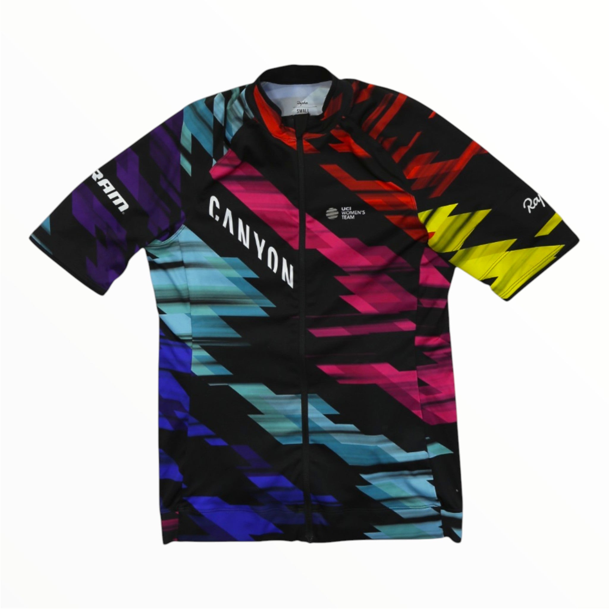 Showcasing bold zigzag patterns in black, red, yellow, blue, and purple, the Rapha Mens Core Jersey by Rapha is a short-sleeved cycling jersey with a front zipper. Designed for fans of men’s cycling apparel, it features “CANYON” printed diagonally across the chest and additional logos on the sleeves.