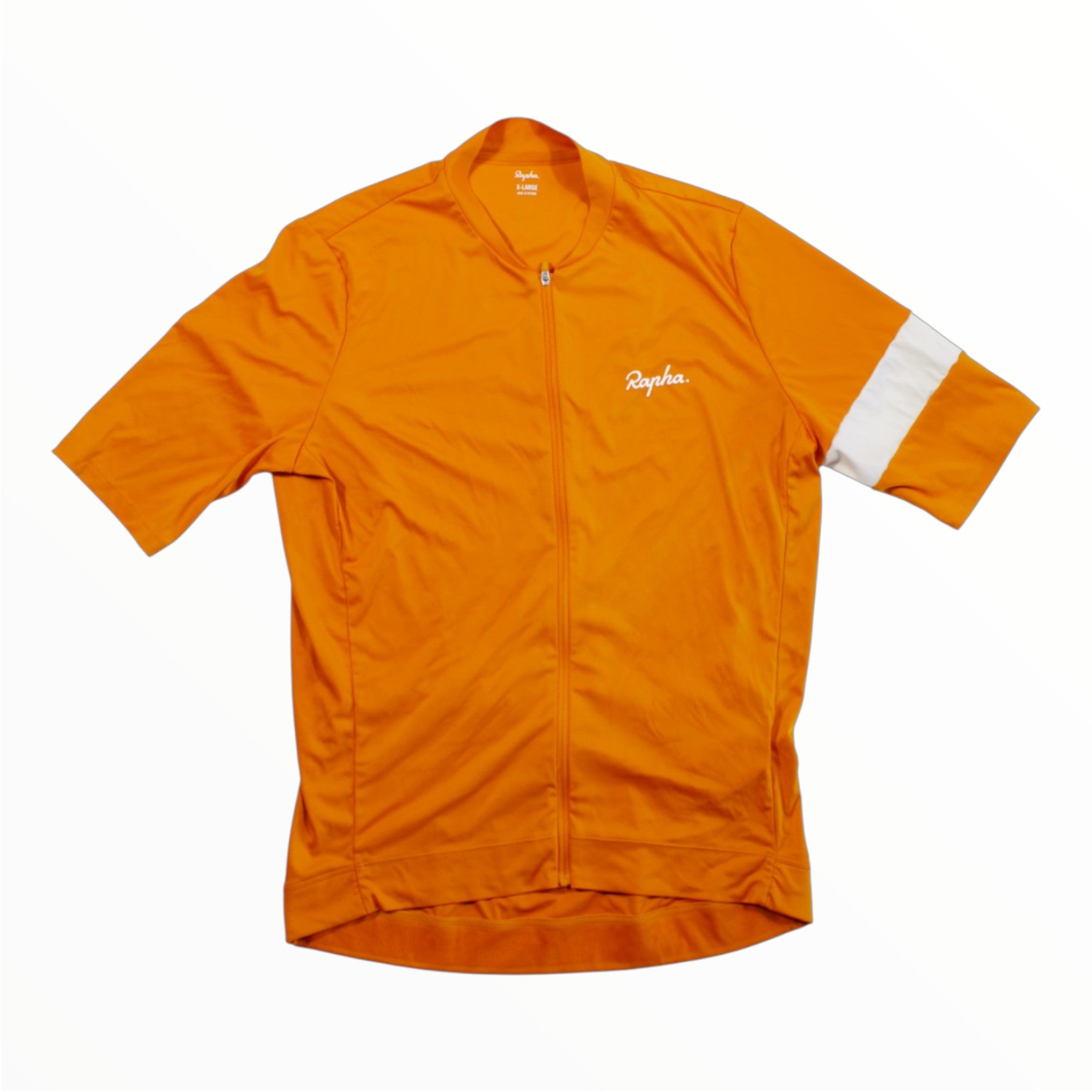 The Rapha Mens Core Jersey by Rapha is a bright orange, short-sleeve cycling jersey featuring a front zipper and a single white band on the left sleeve, shown against a plain white background.