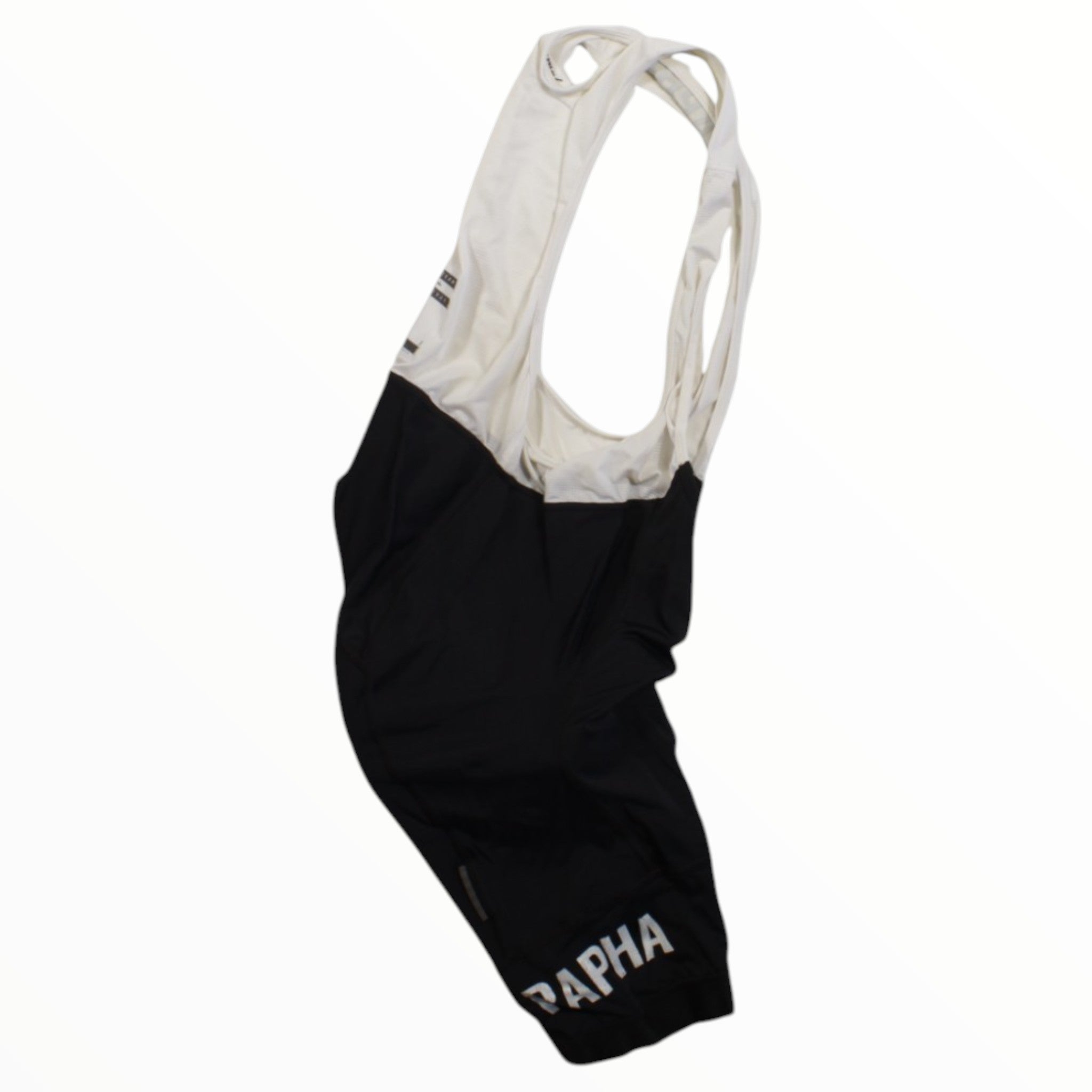 The Rapha Classic Bib Shorts in black and white feature "RAPHA" in white on one leg. Designed for cycling performance, they are showcased against a plain white background.