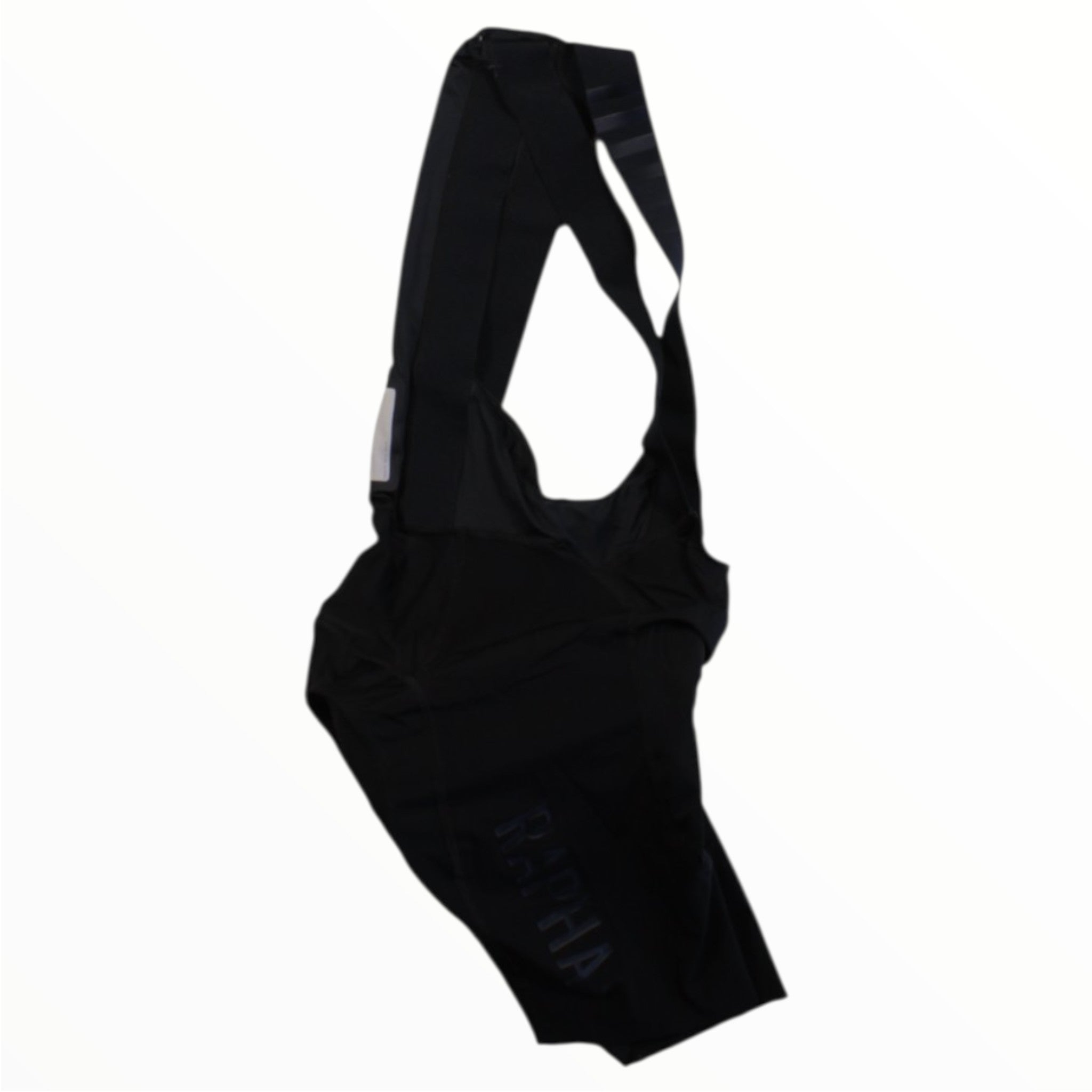 Rapha Classic Bib Shorts, featuring shoulder straps and designed for cycling performance, are laid flat on a white background.