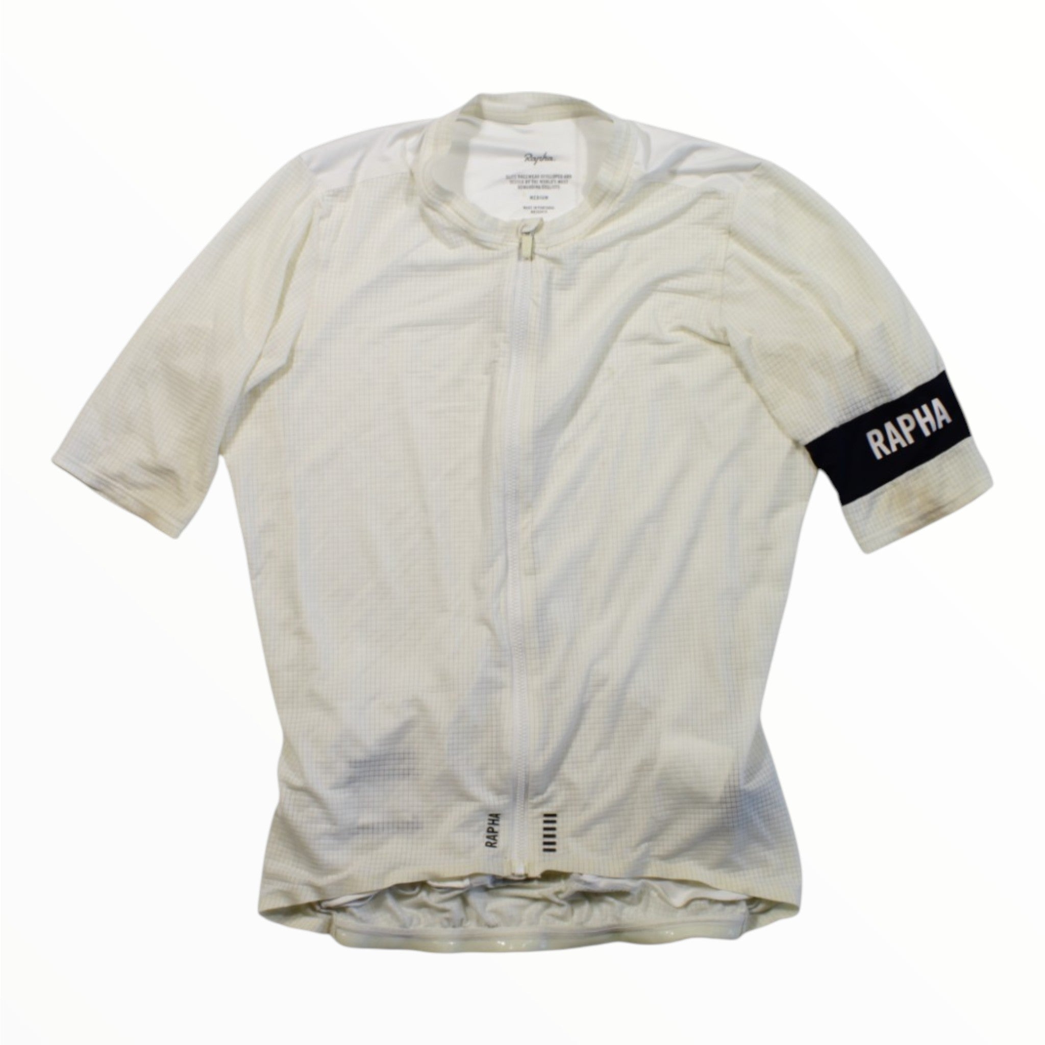 The Rapha Pro Team Flyweight Jersey is an ultralight, short-sleeve white cycling jersey featuring a front zipper and a left black armband with RAPHA in bold white letters.