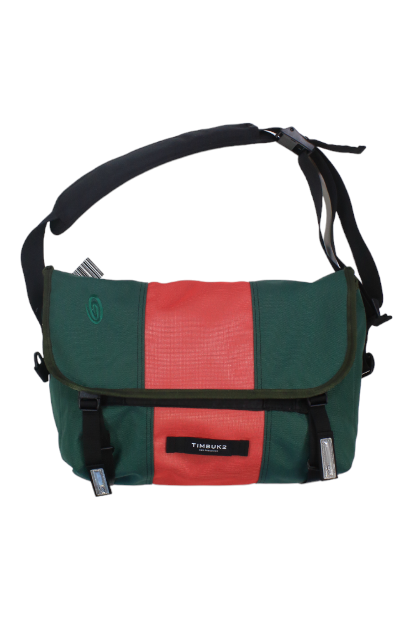 A small messenger bag by Timbuk2, featuring green and red color accents, comes with a black adjustable shoulder strap and secure buckle closures. Its crossbody sling design offers added versatility, and the front flap displays a visible Timbuk2 label.