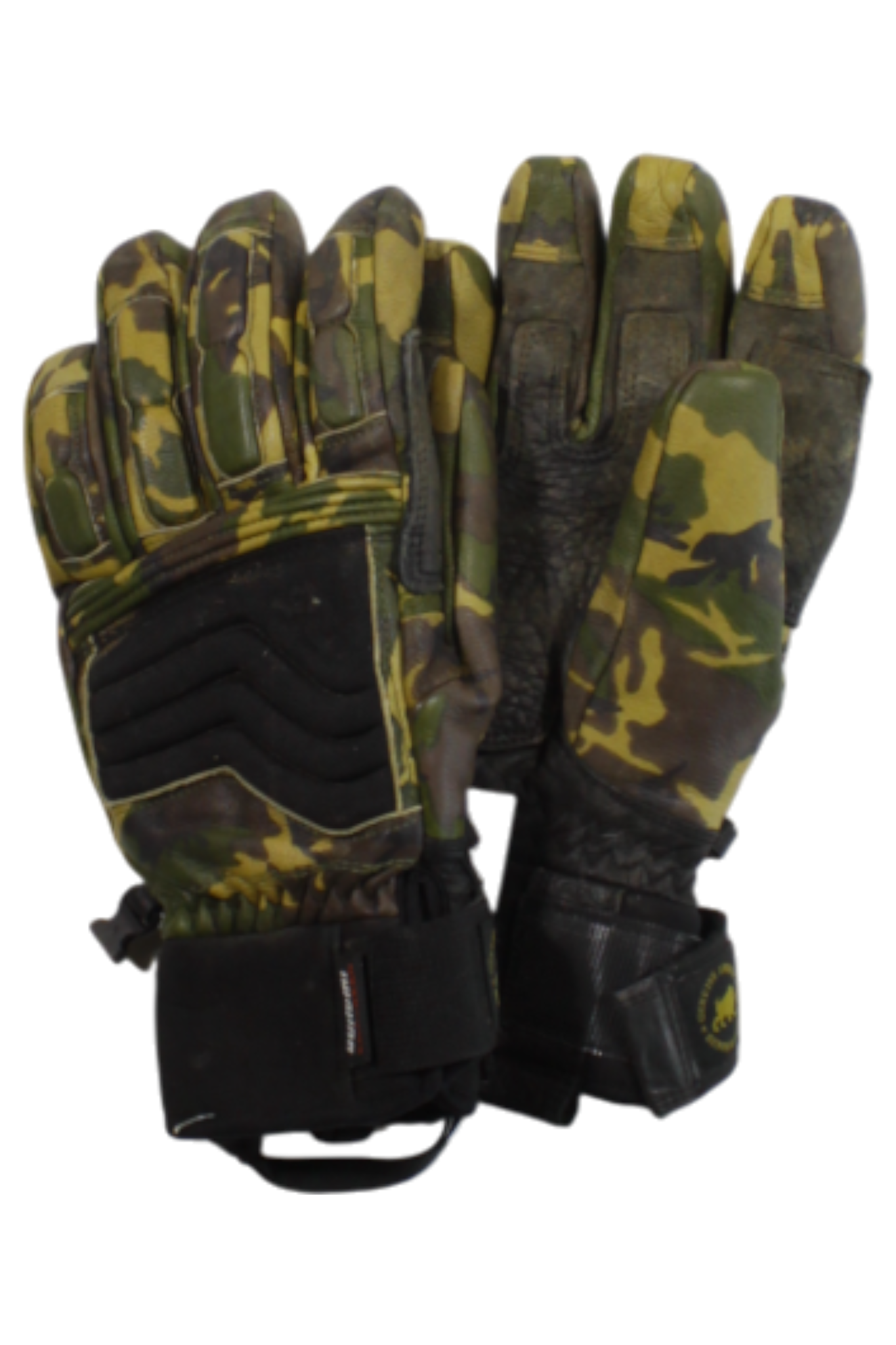The Gordini Wrangell Gloves are camouflage-patterned outdoor gloves with black reinforced areas and adjustable wrist straps, designed for outdoor or military use, shown against a white background.