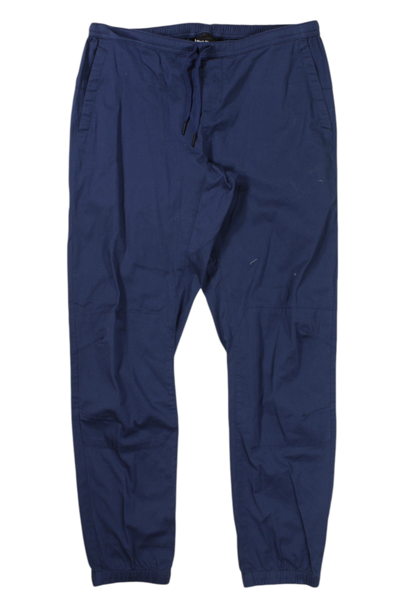 The Womens Notion Pant in navy blue features 4-way stretch fabric, an elastic waistband with drawstring, side pockets, and elastic ankle cuffs—a versatile climbing jogger shown flat on a white background.