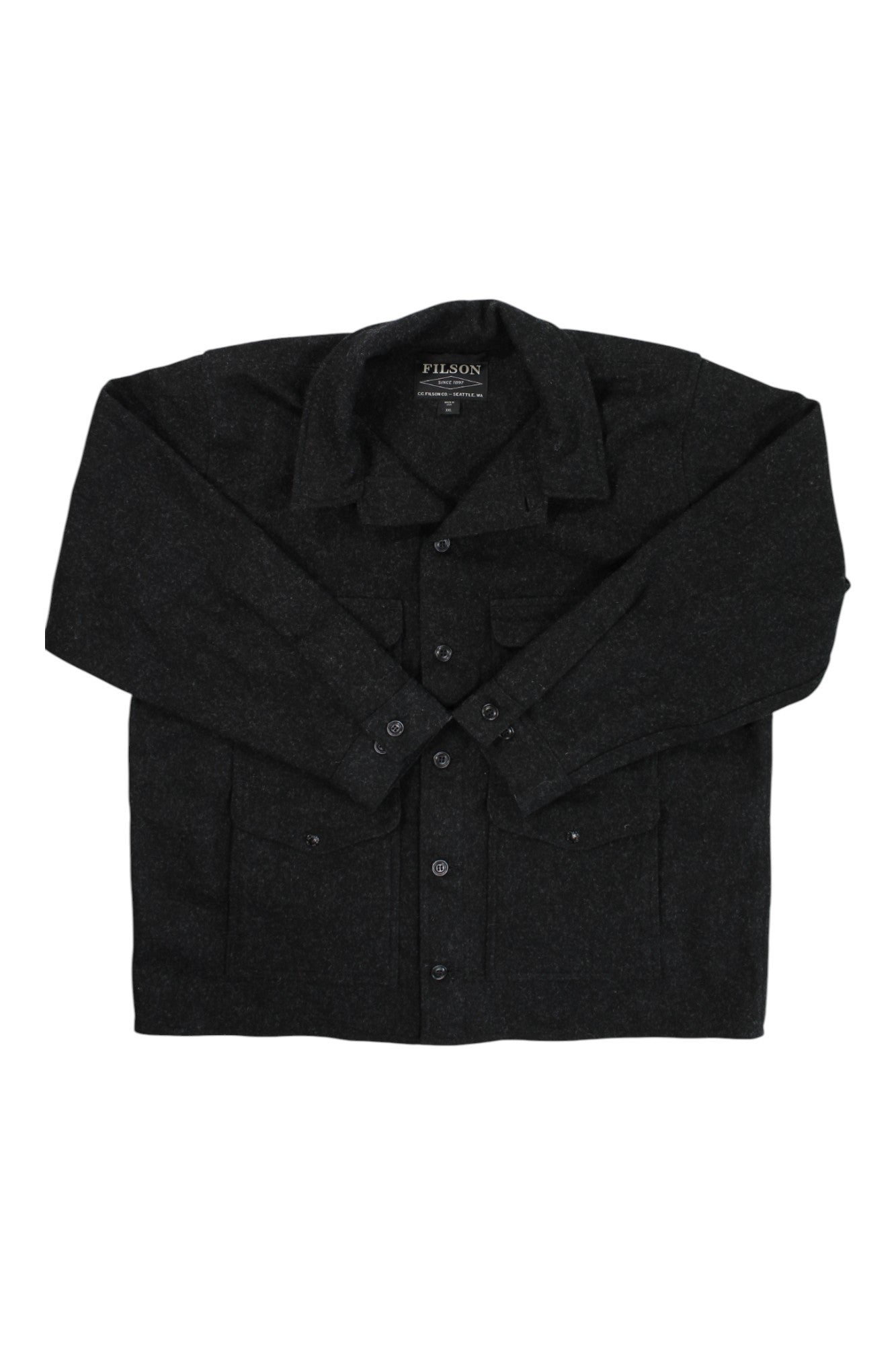 The Filson Mens Mackinaw Cruiser Jacket in dark gray, made from premium wool, features a button-up front, collar, and two chest pockets. It is laid flat on a white background with the brand label visible inside.