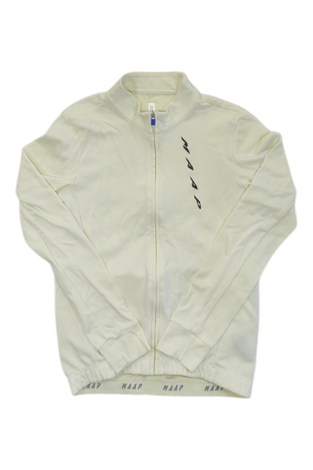 The Team Fit Jersey is a cream zip-up jacket with MAAP printed diagonally on the chest and inner waistband, shown flat on a white background—ideal as a stylish, breathable cycling top for fashion-forward riders.