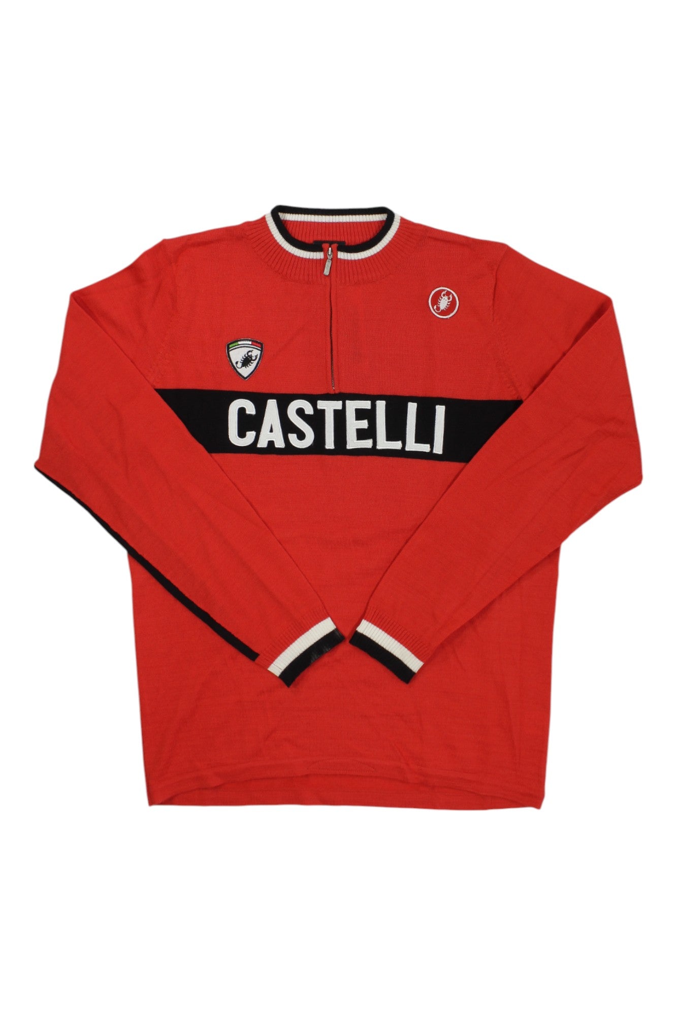 The Mens Castelli Amrando Jersey is a red long-sleeve cycling jersey with a black chest stripe, white CASTELLI text, moisture-wicking fabric, a short front zipper, and two small logos on the upper chest.