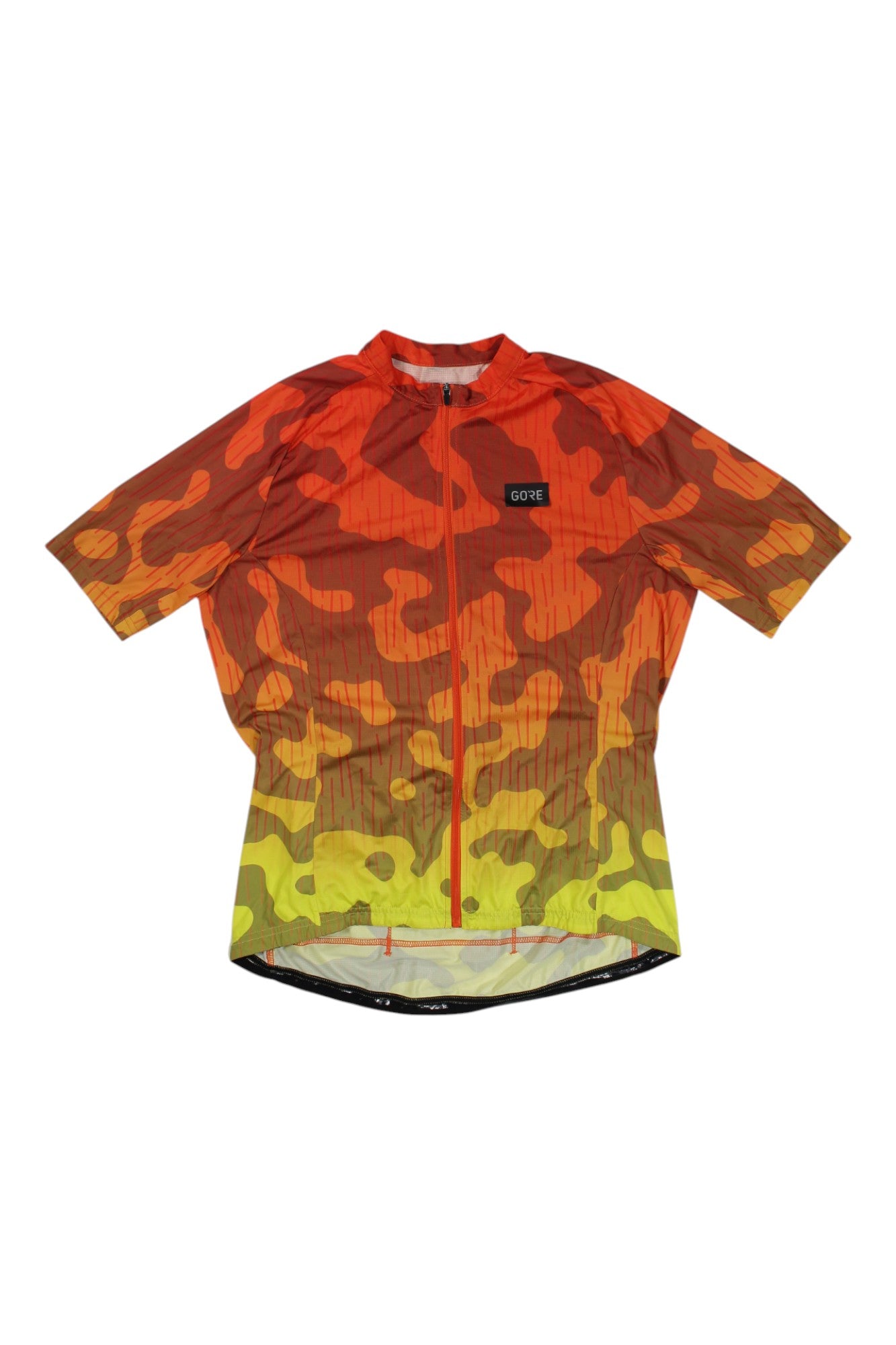 The Gorewear Womens Rain Camo Fire Jersey is a short-sleeve cycling top with a front zipper, featuring an orange, red, and yellow camo print and a black GORE logo patch. This breathable jersey keeps you comfortable on every ride.