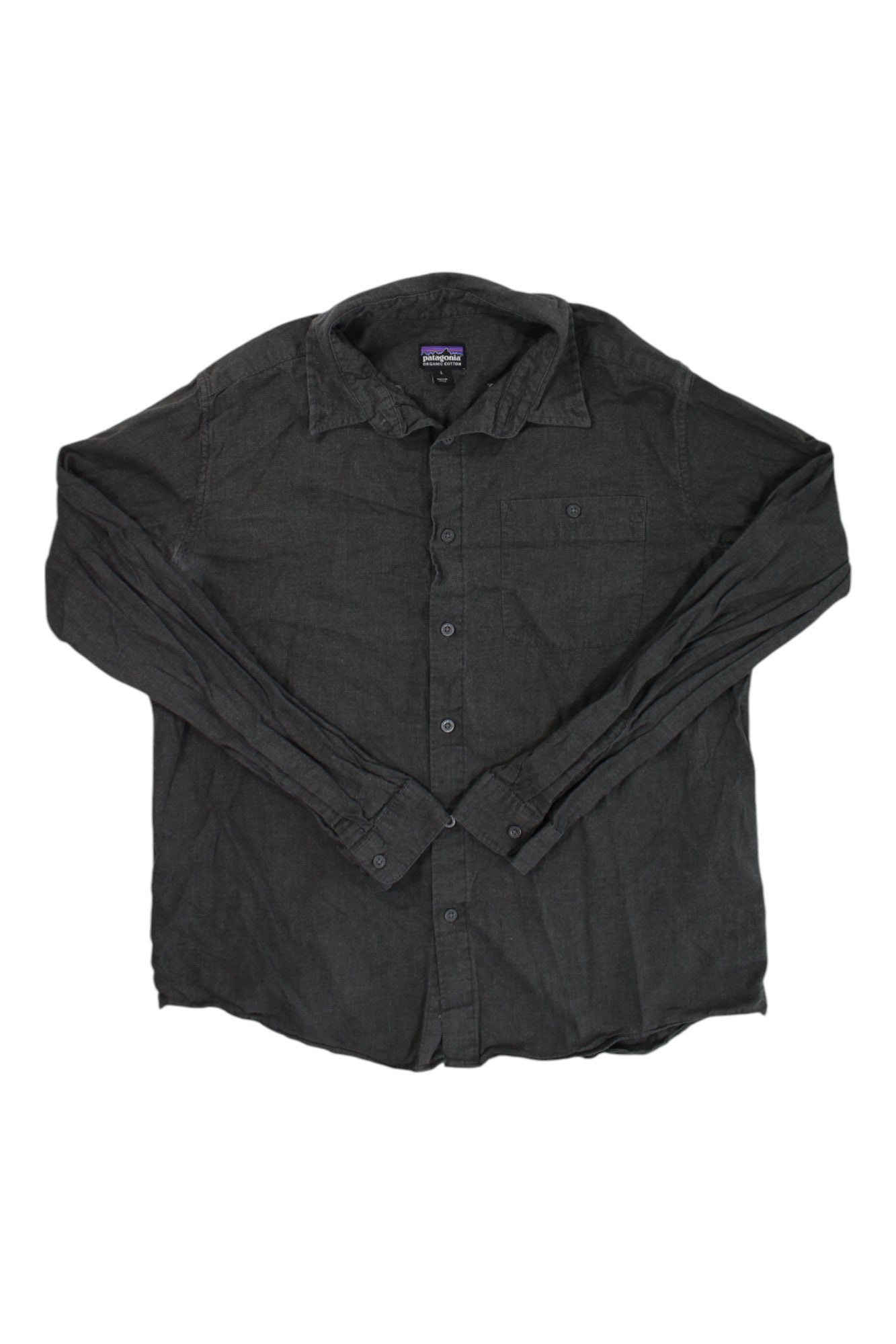 The Mens Long-Sleeved Vjosa River Pima Cotton Shirt is a button-up, dark gray shirt with a collar and single chest pocket, shown laid flat on white—an ideal travel-friendly vacation top.