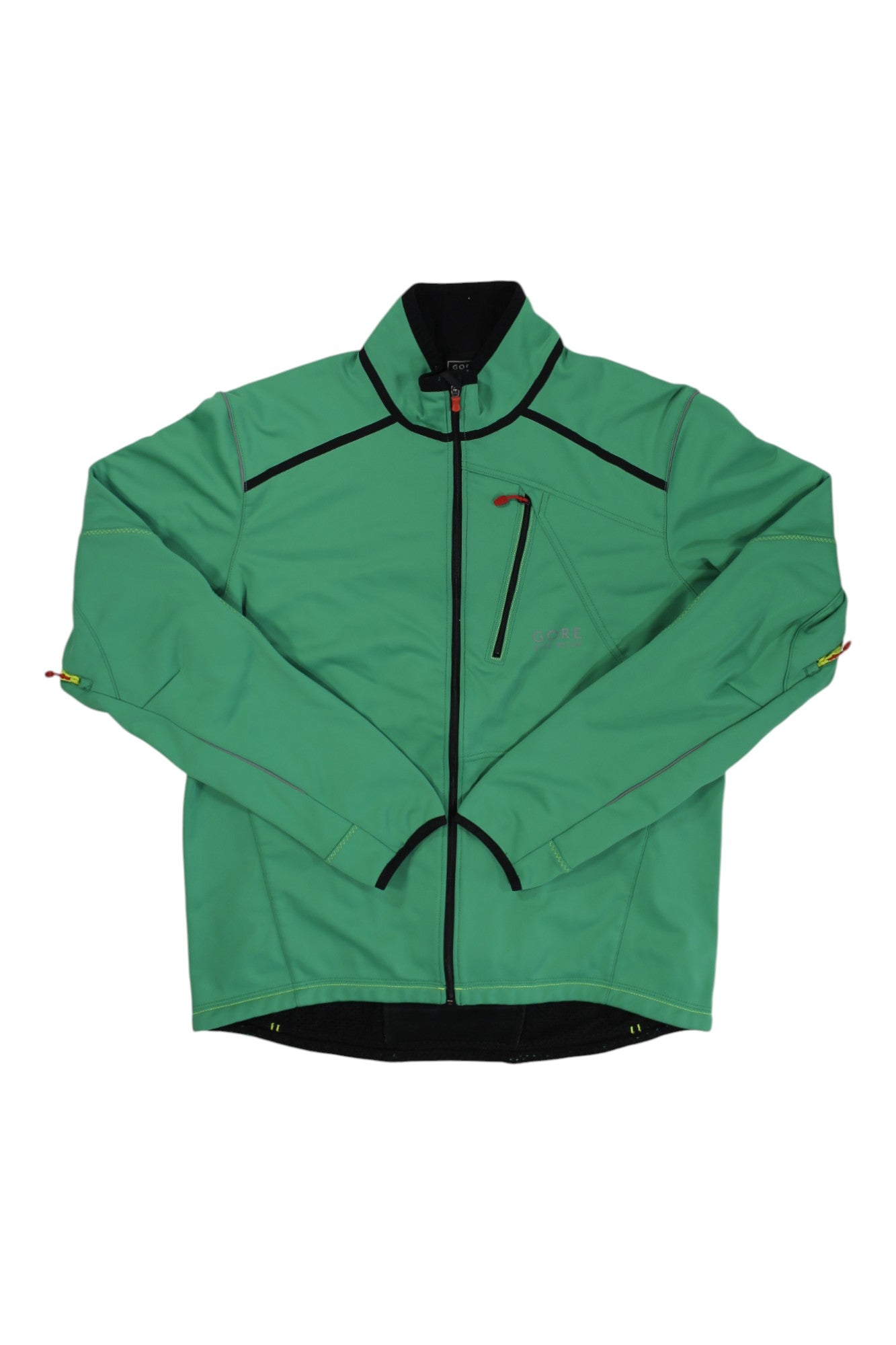 The Gore Bike Wear Windstopper Soft Shell is a green cycling jacket with black trim, high collar, zippered chest pocket, and breathable fabric. Zippered cuffs feature red and yellow pull tabs. Shown laid flat on a white background.