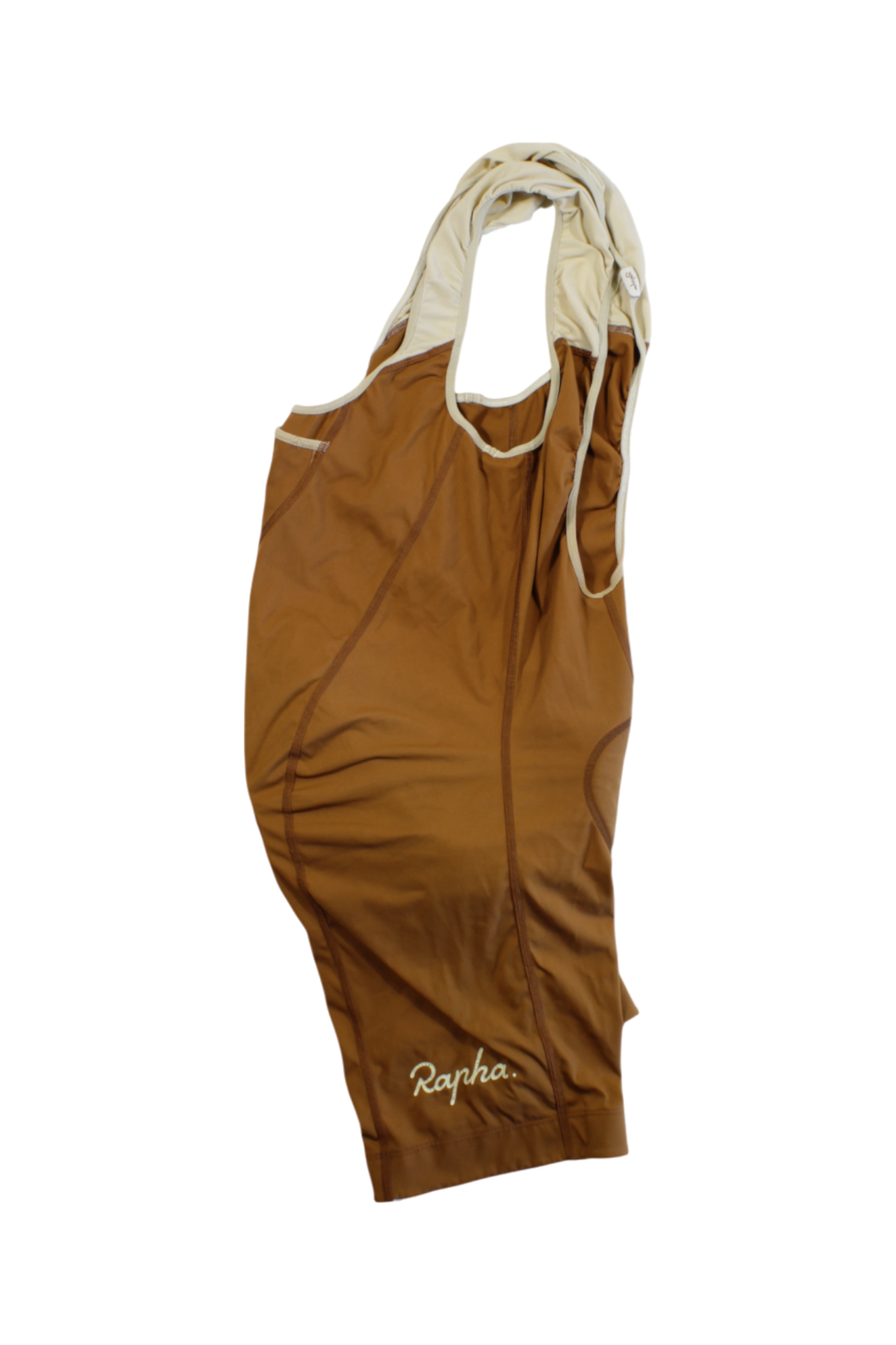 A pair of Rapha Classic Bib Shorts is laid flat on a white background, showing the front and cream-colored shoulder straps—premium cycling shorts designed for peak performance.