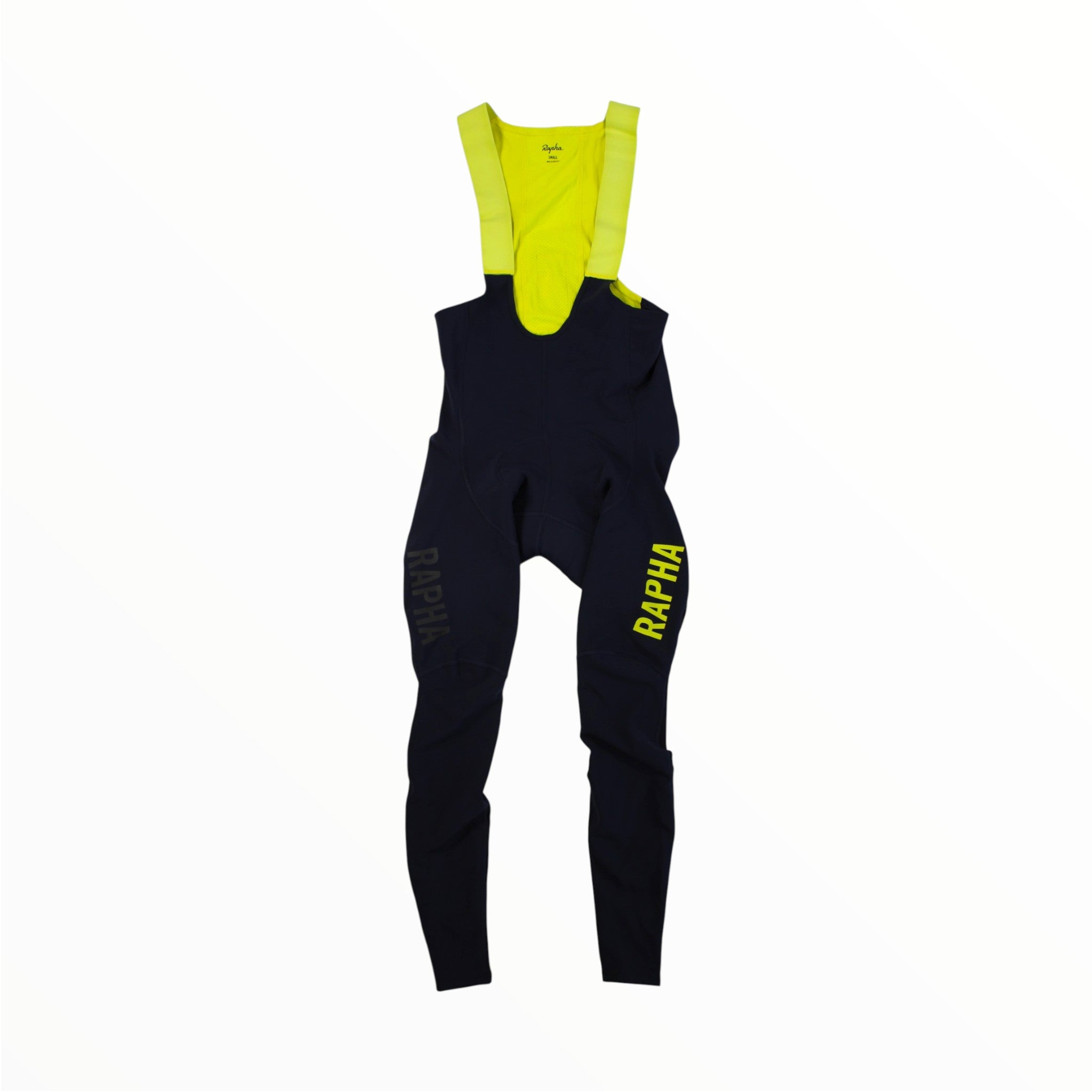 Navy blue Rapha Mens Pro Team Winter Tights with Pad II featuring bright yellow straps and upper section. The RAPHA logo appears on both legs—one in yellow and one in dark gray—making these tights from Rapha an essential addition to your winter cycling clothing collection.