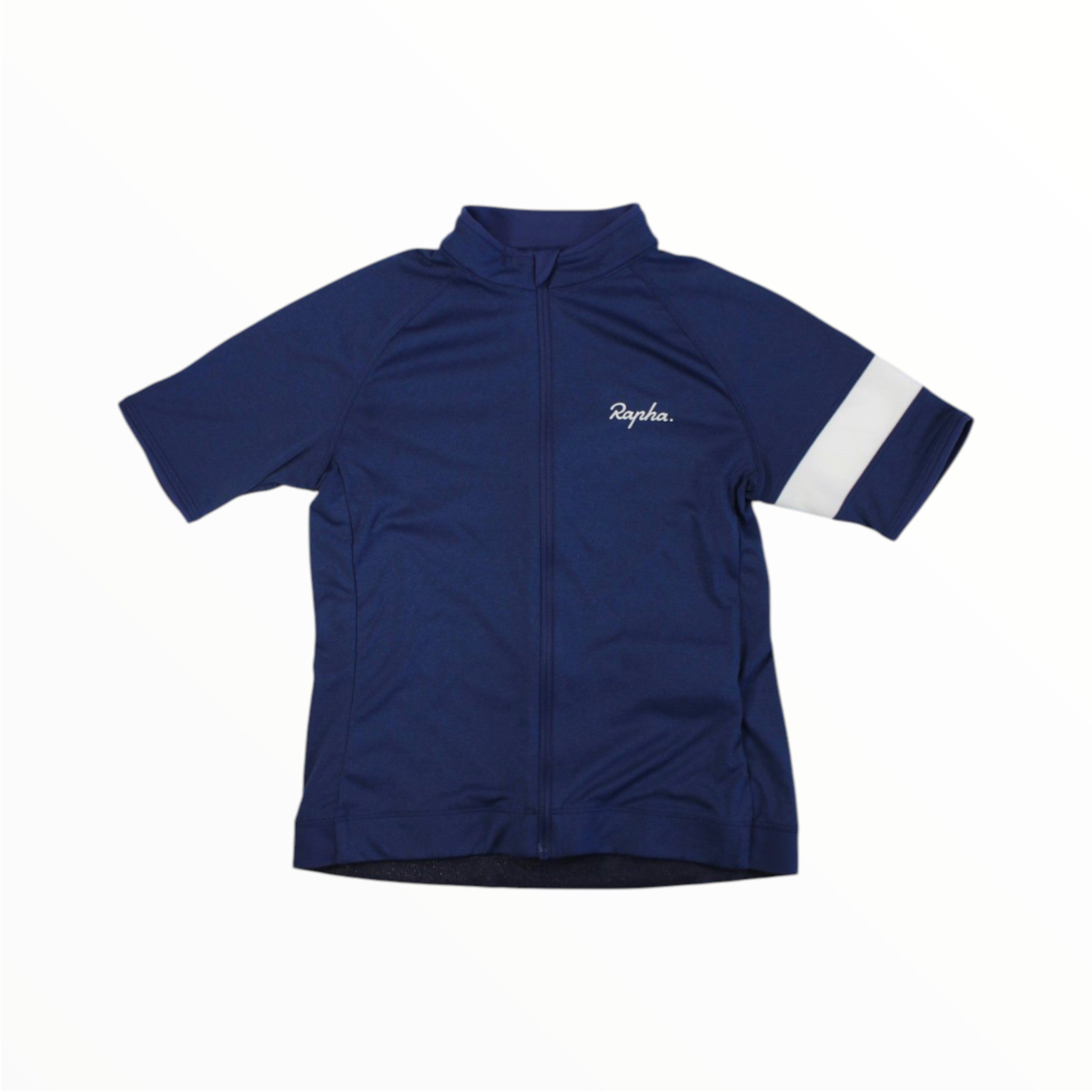 The Rapha Kids Core Jersey in navy blue features short sleeves, a distinctive white arm stripe, and the signature Rapha logo on the chest. Designed for young cyclists, this children's cycling jersey combines style and comfort with breathable performance. It is shown laid flat on a white background.