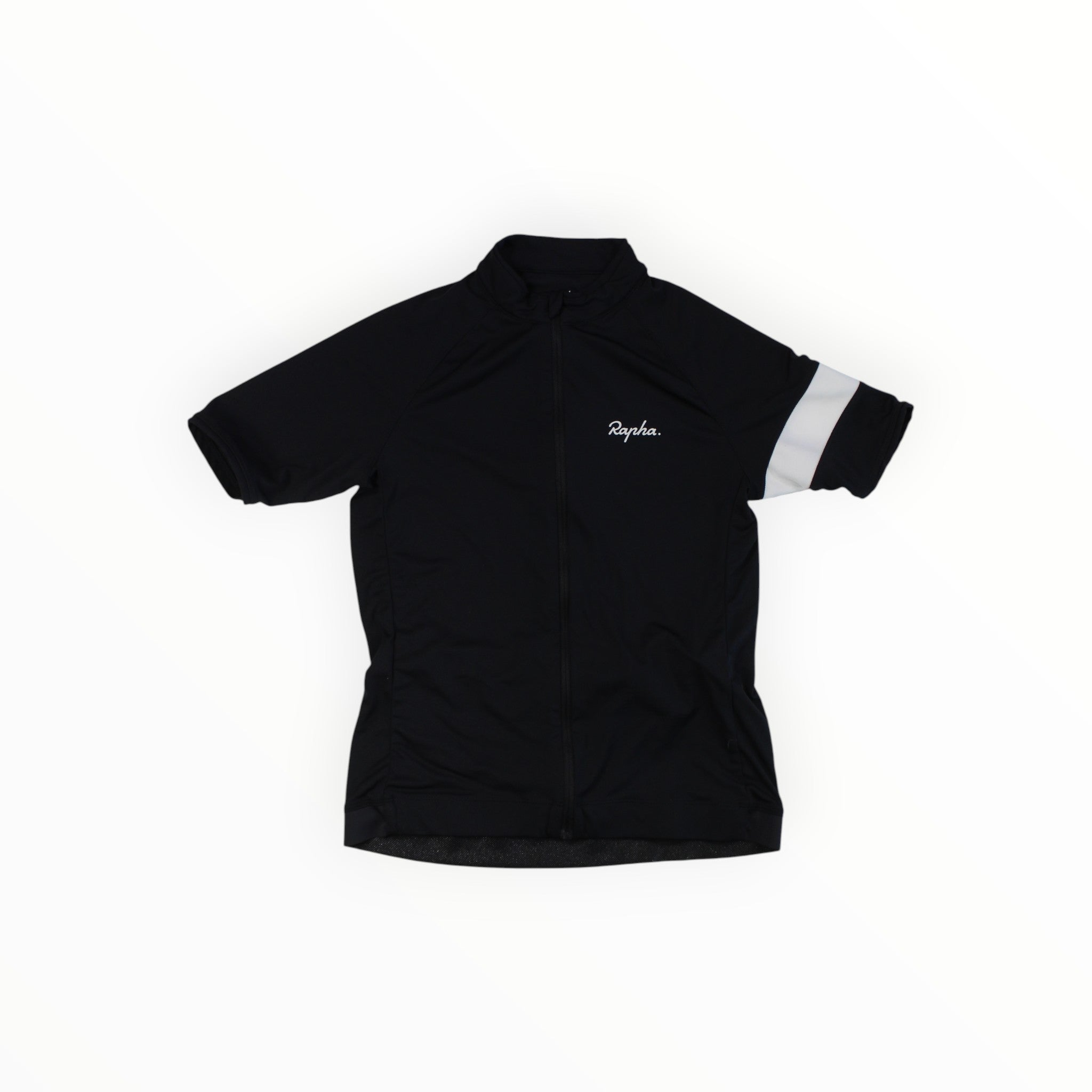The Rapha Kids Core Jersey is a black short-sleeve, breathable cycling jersey featuring a zip front, the white Rapha logo on the chest, and a single white stripe on the left sleeve, shown laid flat on a white background.