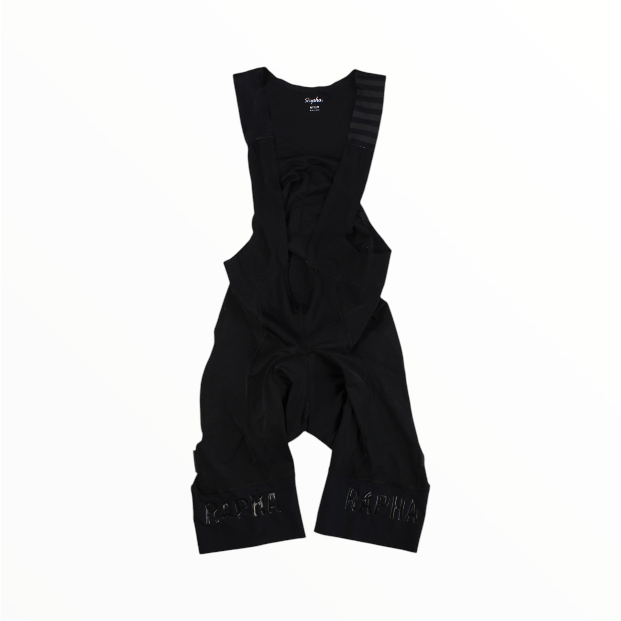 Black cycling bib shorts with small logo at center and reflective detail on each leg
