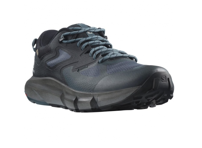 The Salomon Mens Predict Hike GTX Shoe is a dark gray hiking shoe with blue-gray laces, a thick textured sole, and rugged tread, shown from the front left side.