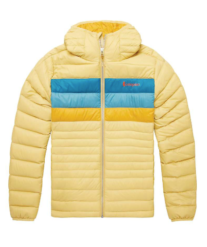 The Cotopaxi Women's Fuego Down Hooded Jacket is light yellow with lightweight, responsibly-sourced down, a hood, front zipper, blue and yellow chest stripes, and an orange Cotopaxi logo on the left chest.