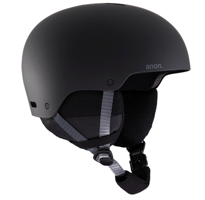 The Anon Junior's Rime 3 Multi-Season Helmet in matte black features ear coverings, a gray adjustable chin strap, and “anon.” branding on the side, providing youth freeride protection for snow sports.