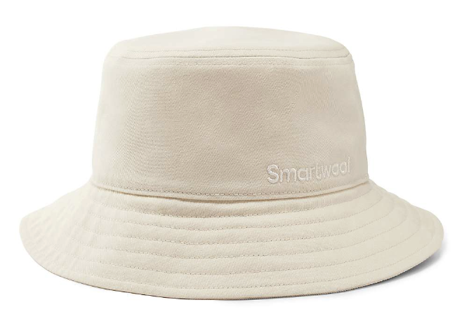 The Smartwool Bucket Hat is beige with visible stitching and "Smartwool" embroidered in white on the front. It offers moisture-wicking comfort and UPF 50+ sun protection, making it stylish and functional for outdoor use.