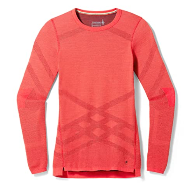 The Smartwool Womens Intraknit Thermal Merino Base Layer Crew is a long-sleeve, crew-neck women’s sweater in bright coral with subtle geometric patterns and ribbed cuffs, shown on a plain white background.