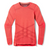 The Smartwool Womens Intraknit Thermal Merino Base Layer Crew is a long-sleeve, crew-neck women’s sweater in bright coral with subtle geometric patterns and ribbed cuffs, shown on a plain white background.