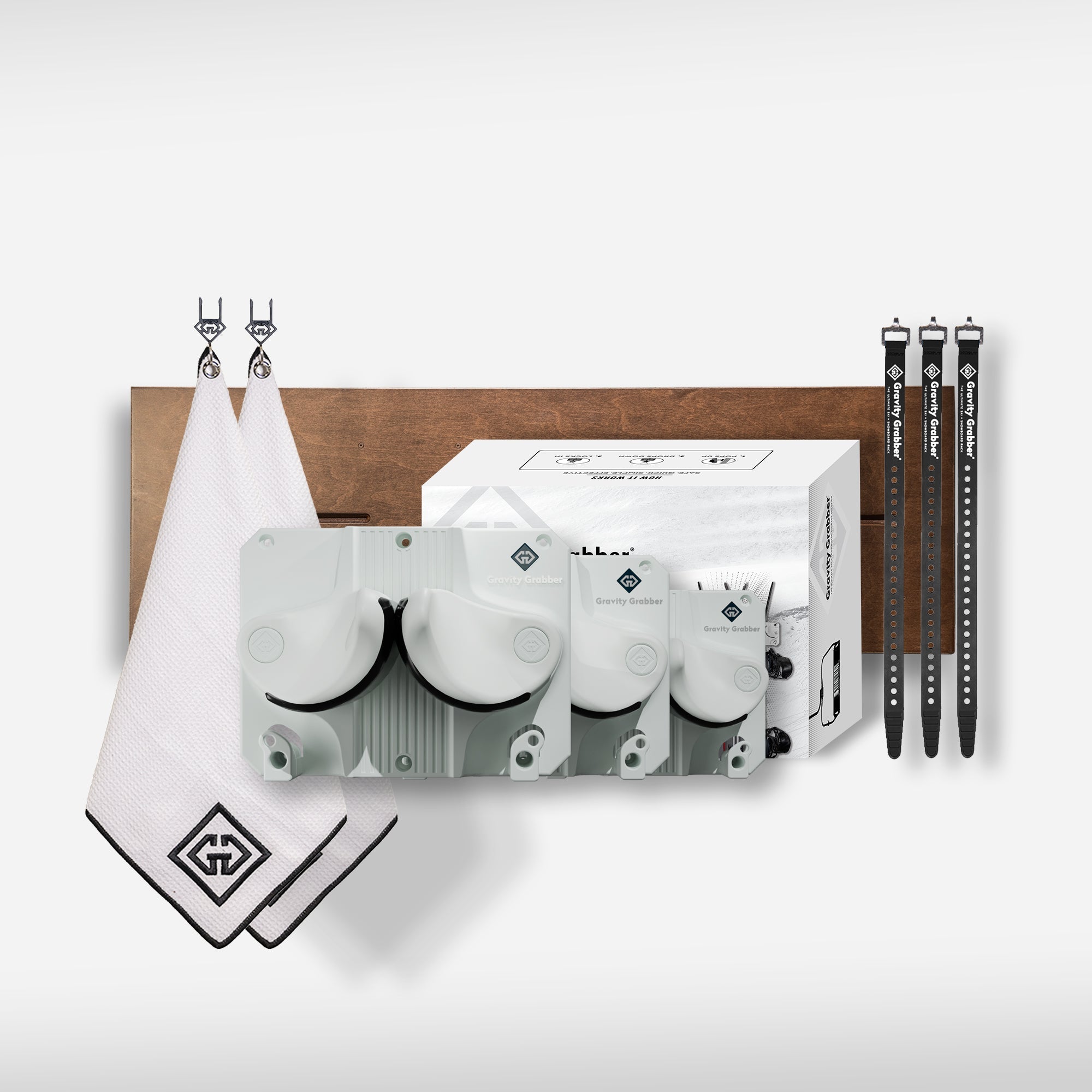 The White Bundle Maple Board includes two white towels with black trim, three golf ball containers in various sizes, a white box, and three black alignment sticks—ideal for organizing your golf gear.