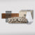 The Wood Bundle Maple Board features wall-mounted shelves, a ski and snowboard rack, four white logo towels, five black straps, and a large wooden Gravity Grabber box—displayed on a plain background.
