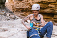 a rock climber grabbing her beverage