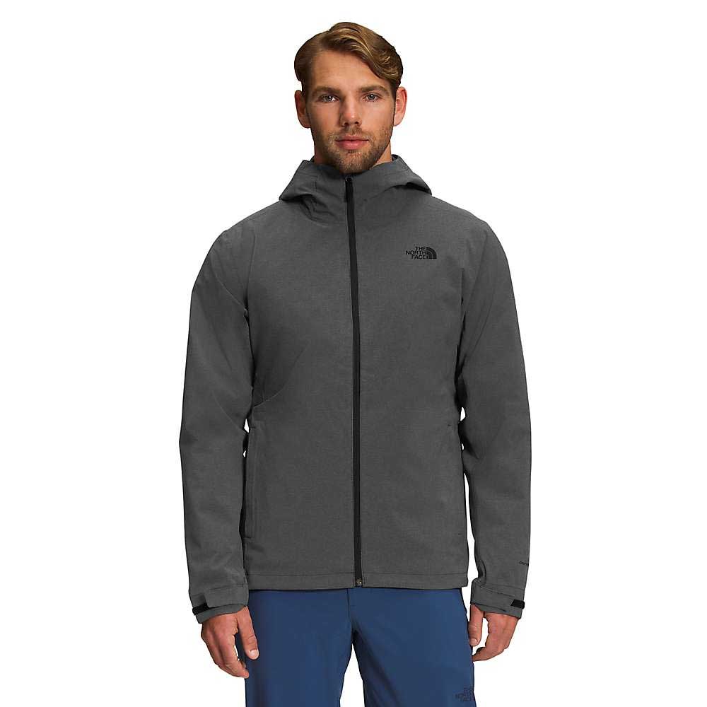 A man wearing a gray The North Face Mens Thermoball Eco Triclimate Jacket with a front zipper stands facing forward against a plain white background.