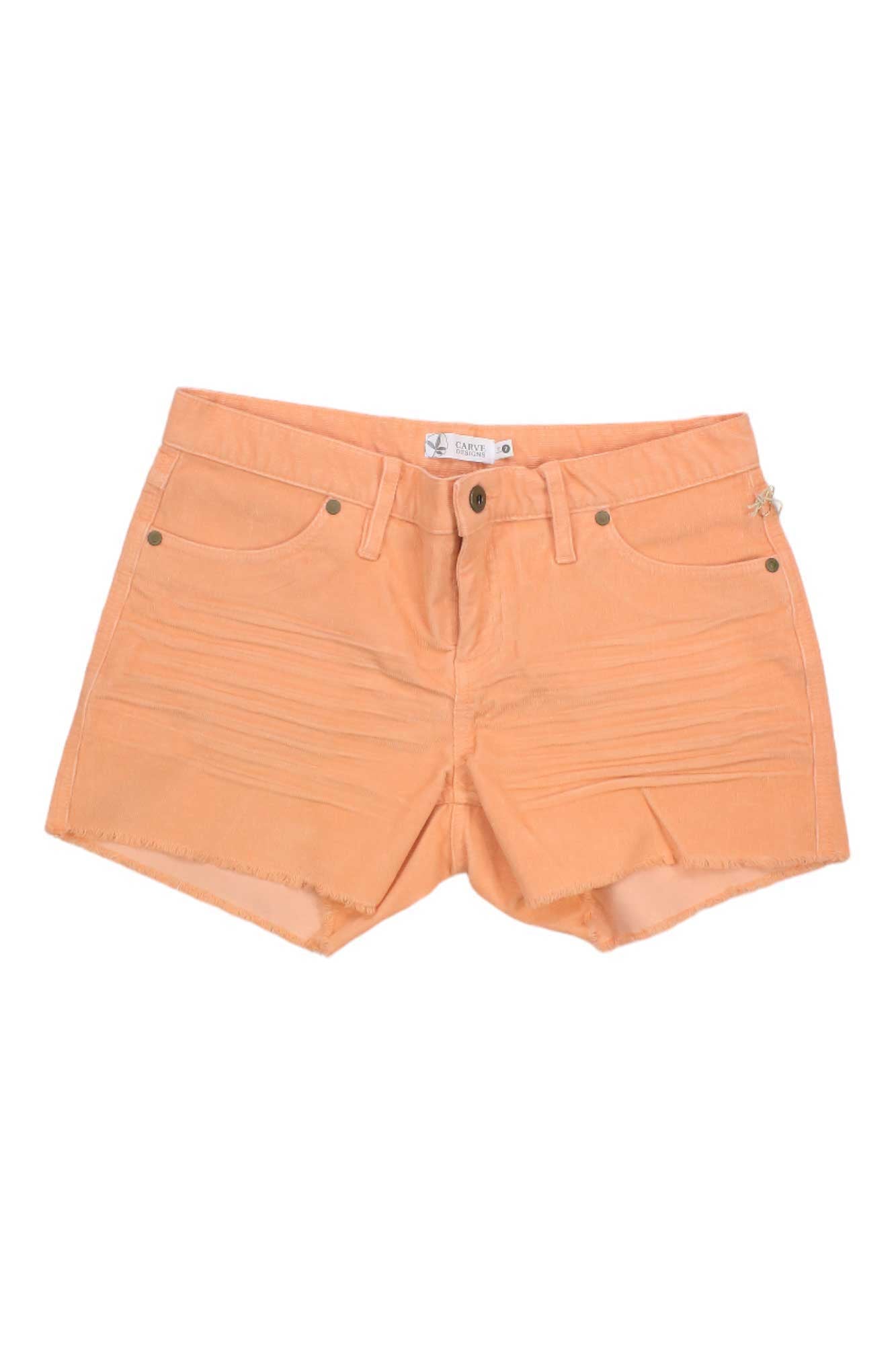 The Carve Designs Women's Oahu 4 Inch Short in peach features front pockets, belt loops, frayed hems, and a slim fit, shown laid flat on a white background.