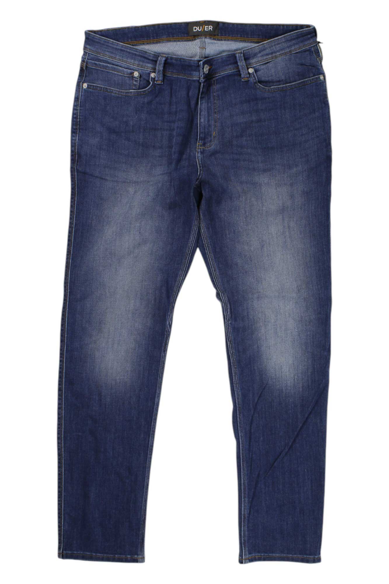 Medium rinse blue slim-fit performance denim jeans, back view with dual pockets