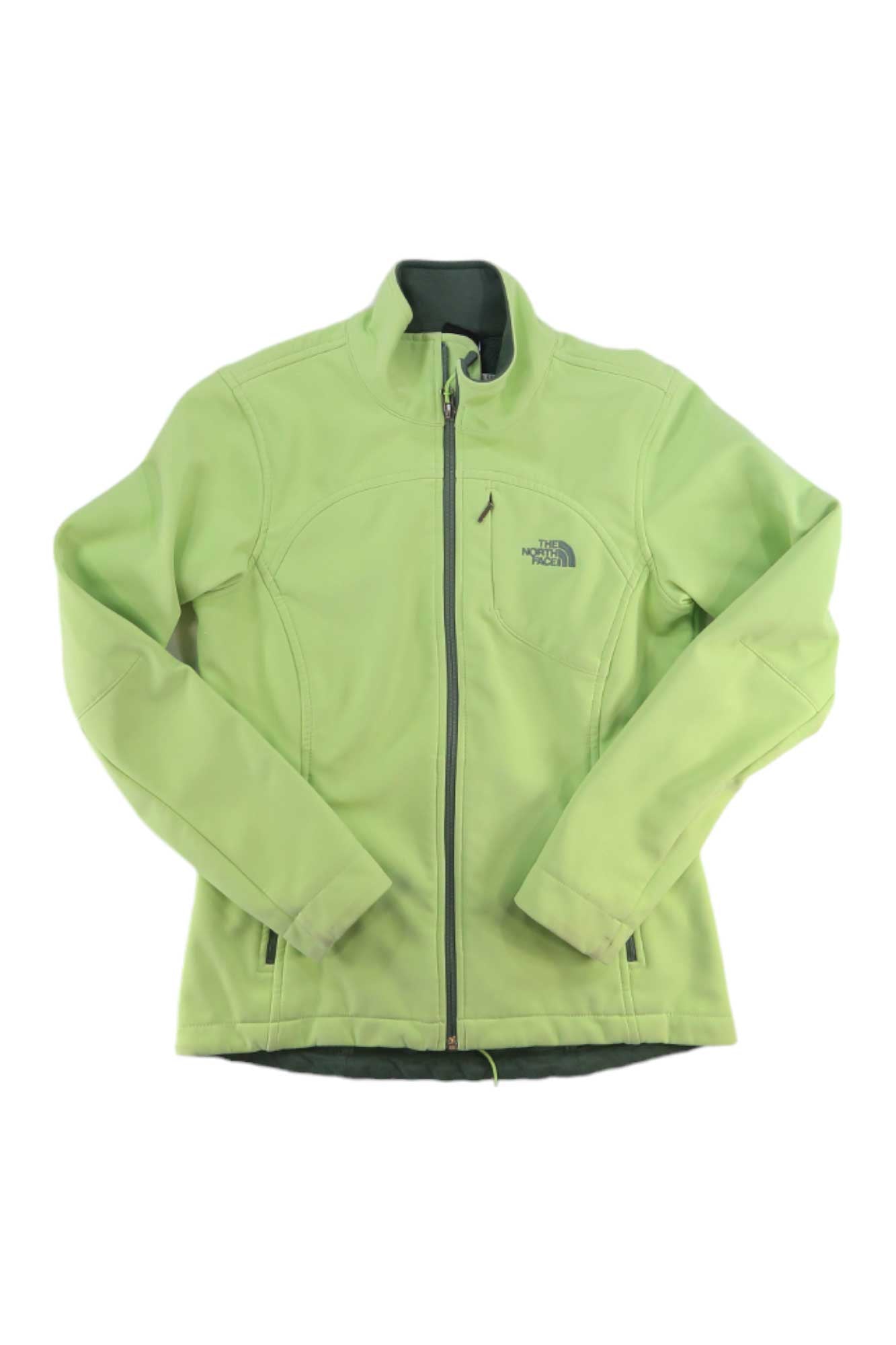 A light green Womens Apex Bionic Soft-Shell Jacket by The North Face, featuring long sleeves, a high collar, and two zippered side pockets, is laid flat on a white background.
