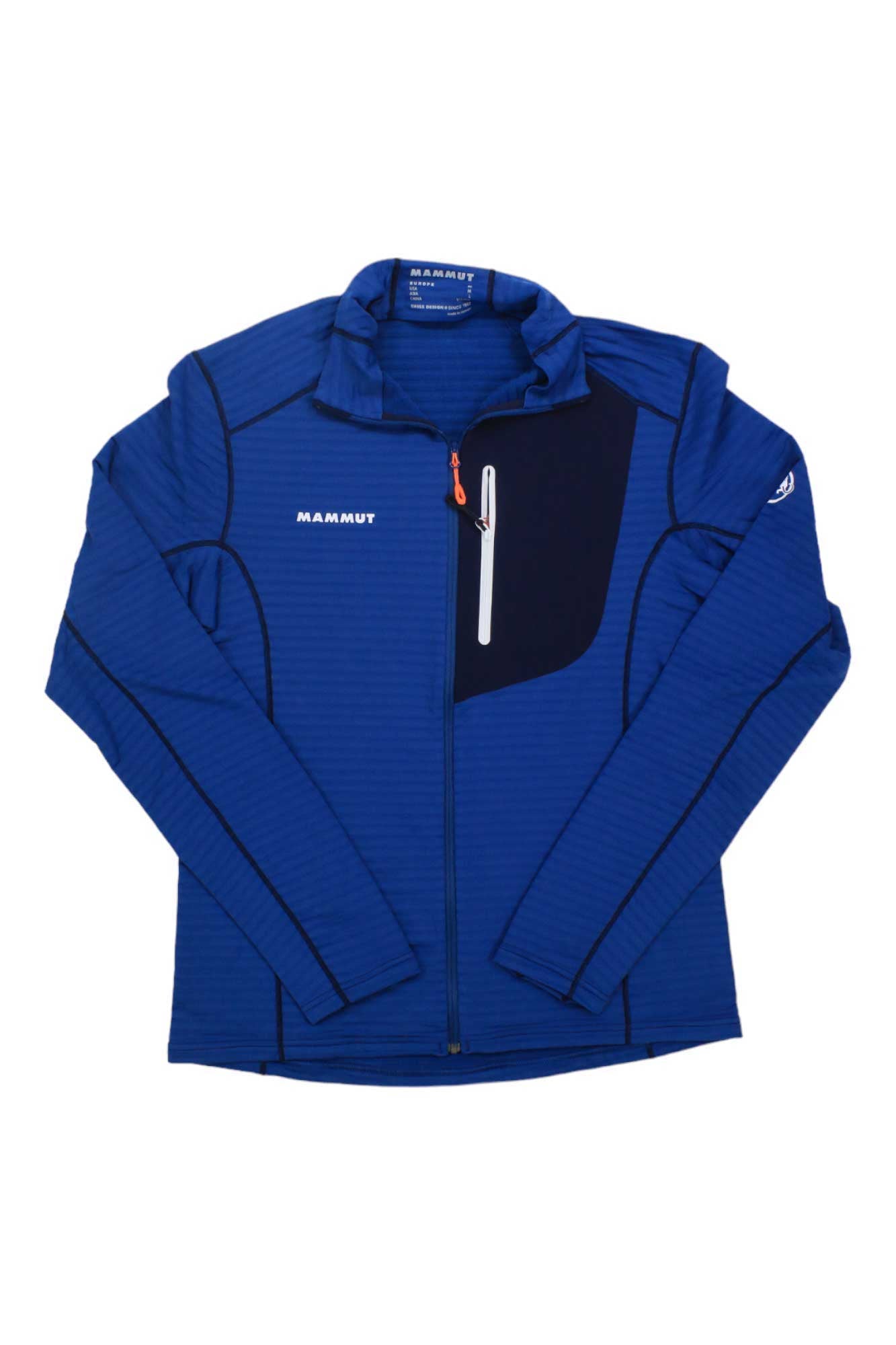 The Mammut Men's Taiss Light ML Jacket is a blue technical fleece with zip front, long sleeves, black shoulder and chest pocket details, and white logos on chest and left sleeve—perfect for snowsports and skiing.