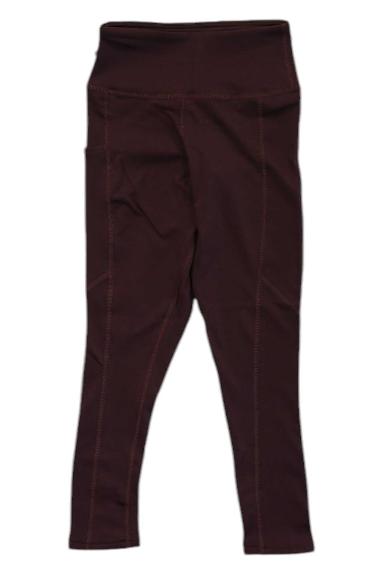 Polarmax Women's Stretch3 Super Mid-Weight Pocket Capri in dark brown, high-waisted with visible seams. Features moisture-wicking fabric, UPF 50+ protection, and pockets—ideal for active lifestyles. Shown laid flat on a white background.