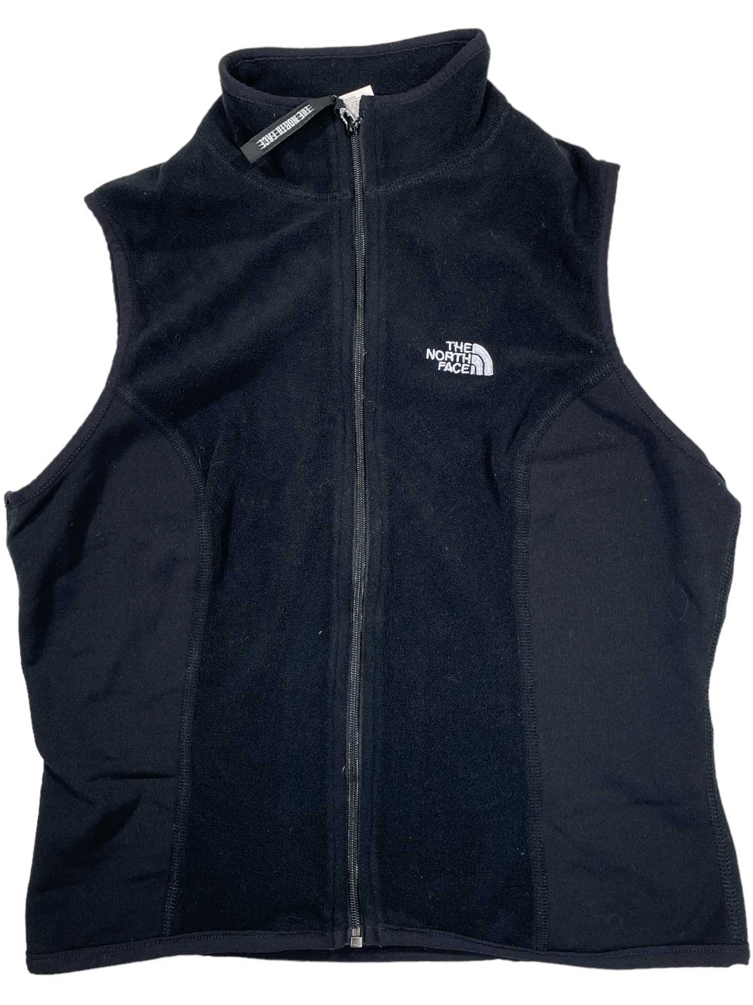The Womens Lightweight Fleece Vest is black with a front zipper, stand-up collar, and The North Face logo on the left chest—great for hiking or layering.