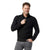 A man with curly hair and a trimmed beard smiles while wearing the Smartwool Men's Hudson Trail Fleece Half Zip Sweater in black and grey jeans, standing against a plain white background.