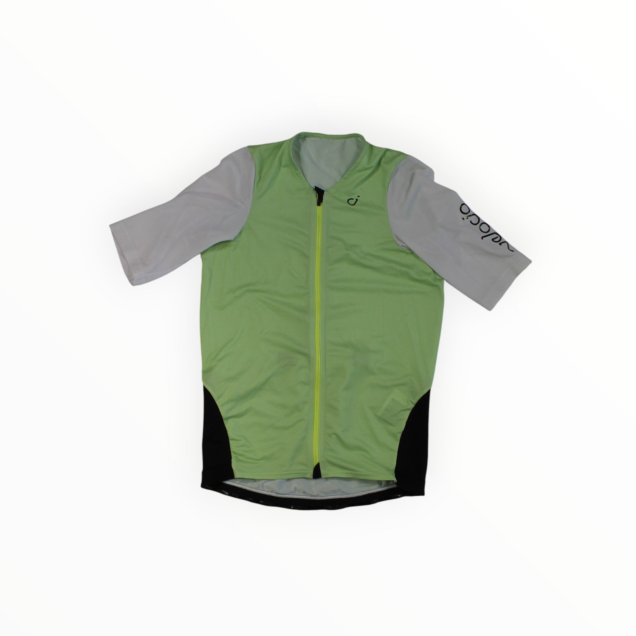 The Velocio Mens Concept SE Jersey is a short-sleeve cycling jersey made from premium Italian fabric, with light green front and back panels, gray sleeves, black side panels, a front zipper, and black text printed near one shoulder.