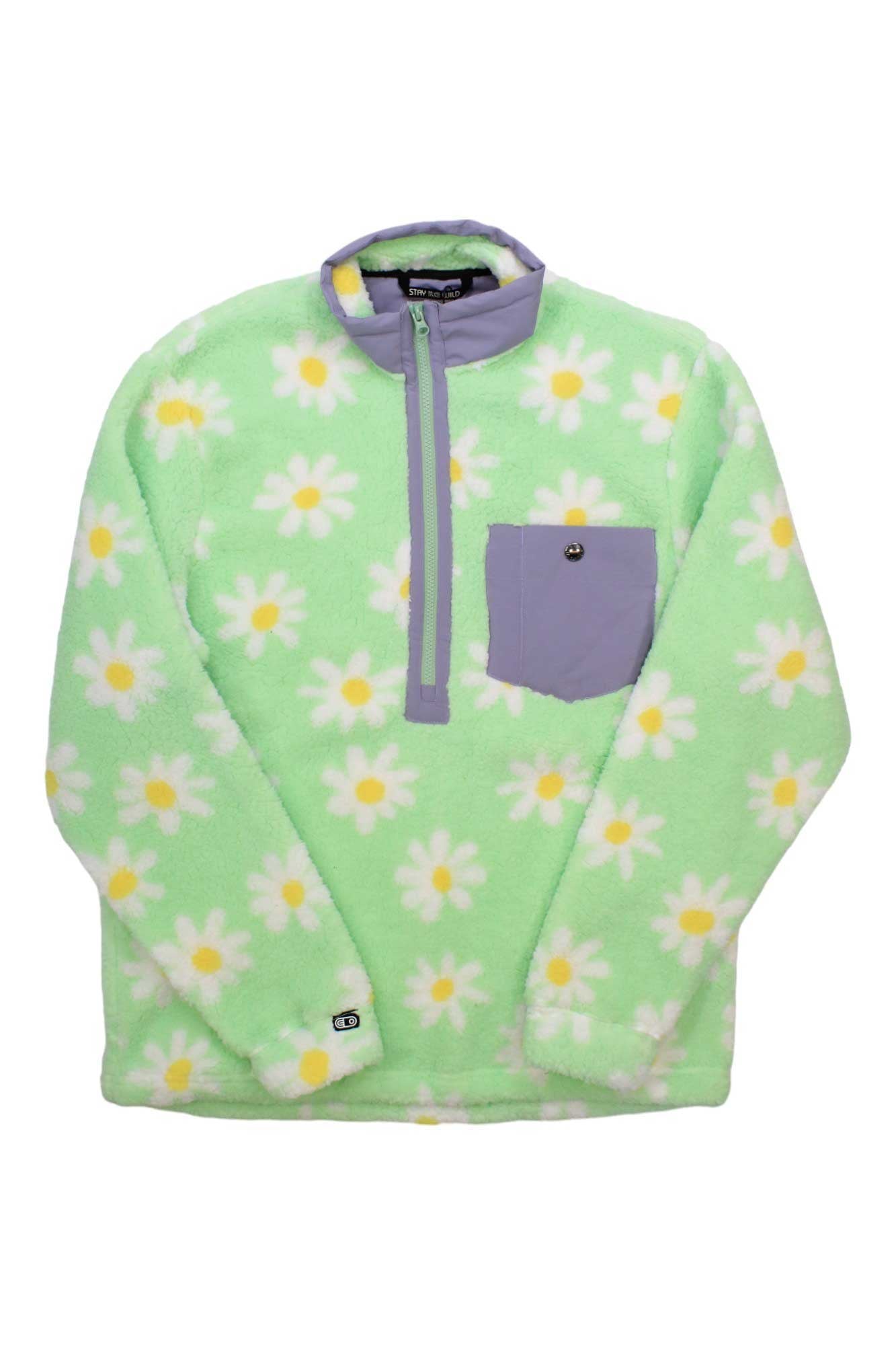 The Airblaster Womens Sherpa Half Zip is a fuzzy, light green fleece pullover with daisy print, a buttoned purple chest pocket, and a matching purple stand collar with half zip closure for cozy comfort.