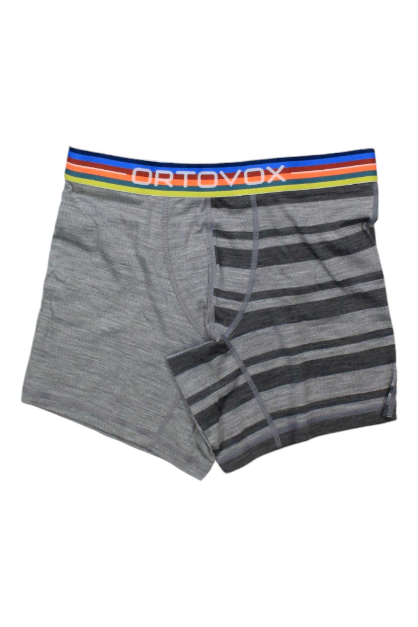 Ortovox Mens 185 RockNWool Boxer: Men’s winter underwear with gray solid color on one side and gray with dark stripes on the other. Features moisture-wicking fabric, a colorful striped waistband, and the ORTOVOX logo in white.